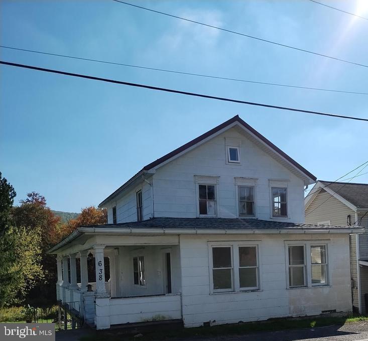 Single family starter home or investment home sits on over a 1/2 acre and is ready for it's new owner!  Enjoy the usable large enclosed front porch, spacious open living room, and wrap around side/back porches that  overlook your big backyard.  Major upgrades include brand new 220 amp panel box, electric baseboard heat, electric water heater, newer metal roof, and new windows throughout 1st and 2nd floors in 2025, along with new interior 2nd floor doors.  Upstairs you'll find 2 bed, 1 bath, and small open bonus area with access to full attic.  Property is selling as-is.  Make this affordable home yours today.