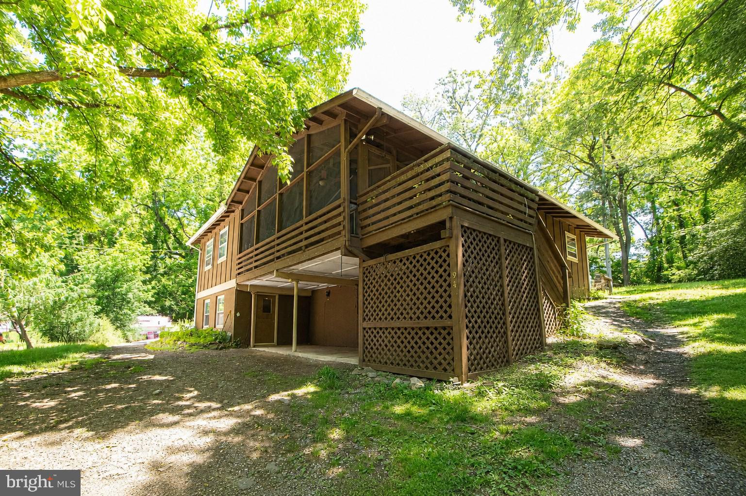 Tucked away on nearly 1.5 private acres, this charming country retreat offers the peaceful setting you’ve been dreaming of! The beautiful living room features a cozy fireplace and double French doors that open onto an incredible screened front porch, creating a true treehouse feel surrounded by nature. It’s the perfect place to relax, unwind, and enjoy the quiet beauty of country living.

This spacious home offers 4 bedrooms and 3 full baths with generously sized bedrooms throughout. The Owner’s Suite includes private access to the screened porch for your own peaceful escape. The walkout basement features newer carpet and opens onto a covered porch area, offering additional outdoor living space.

The wood burning fireplace is new, and the roof is 14 months old. The stunning floors add warmth and character throughout the home. Outside, you’ll also find a storage shed and fenced garden area perfect for gardening, hobbies, or pets. Convenient laundry room located just off the kitchen.