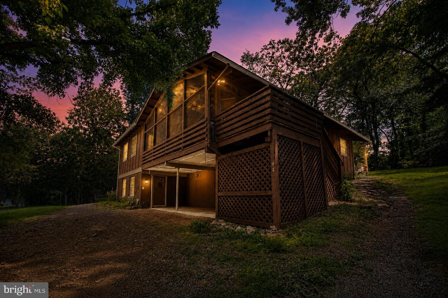 Tucked away on nearly 1.5 private acres across two lots, this charming country retreat offers the peaceful setting you've been dreaming of. Surrounded by nature and nestled among the trees, the home provides a sense of privacy while still offering convenient access to modern amenities and commuter routes.

The inviting living room serves as the heart of the home, featuring a beautiful new wood-burning fireplace and double French doors that open onto an incredible screened front porch. With its elevated views and natural surroundings, the porch creates a true treehouse-like experience—perfect for relaxing with your morning coffee, enjoying a good book, or unwinding after a long day.

Offering 4 spacious bedrooms and 3 full bathrooms, the home provides plenty of room for family and guests. The generously sized Owner's Suite features private access to the screened porch, creating a peaceful personal retreat. The walkout basement includes newer carpet and opens to a covered porch area, extending your outdoor living and entertaining options.

Natural light and comfortable living spaces create a welcoming environment. A conveniently located laundry room just off the kitchen enhances everyday functionality. Outside, you'll find a storage shed, a fenced in garden area, and a spacious backyard. The two lots combine to create approximately 1.4 acres, providing additional privacy, room to roam, and endless possibilities for outdoor enjoyment.

The roof was replaced just 14 months ago, and the wood-burning fireplace is new, offering added peace of mind for years to come.

Residents enjoy access to community amenities including Deer Lake and Blue Mountain Lodge. High-speed internet is available, making remote work and streaming a breeze. Located just minutes from I-66, this property offers an ideal commuter location while remaining close to hiking trails, wineries, golf courses, restaurants, and all the conveniences of the Town of Front Royal.

The property is located within a Sanitary District, with fees conveniently included in the real estate taxes.

Whether you're searching for a full-time residence, weekend getaway, or mountain retreat, this unique property combines privacy, character, and convenience in one beautiful package.