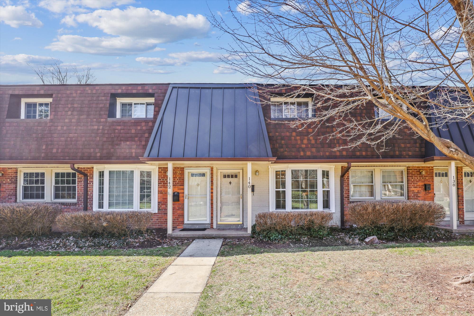 Step inside this charming and bright 2-bedroom, 1.5-bathroom condo townhome, offering a spacious and open floorplan with a beautiful bay window that fills the space with natural light, located in the sought-after Winter Hill community in Falls Church City!  The gleaming hardwood floors flow throughout both levels, complemented by stylish wood shelving in the living room, primary bedroom and bathrooms. The gourmet kitchen boasts sleek granite countertops, a stylish backsplash, and plenty of cabinet space, with convenient access to a private back patio – perfect for outdoor relaxation. The inviting half bath, located off the living and dining areas, features an updated vanity and a striking, unique wood ceiling. On the upper level, you'll find a generous primary bedroom with dual closets, alongside an additional cozy bedroom. A full-size bath on this level adds to the home's convenience, and a full laundry setup completes the second floor. Tucked away on a peaceful private walkway, this home also offers a fully fenced backyard patio – an ideal retreat for privacy and entertaining – along with an assigned parking space. Just moments from the heart of Falls Church City, enjoy easy access to a vibrant selection of coffee shops, boutique shopping, and a variety of restaurants. Falls Church City Schools!