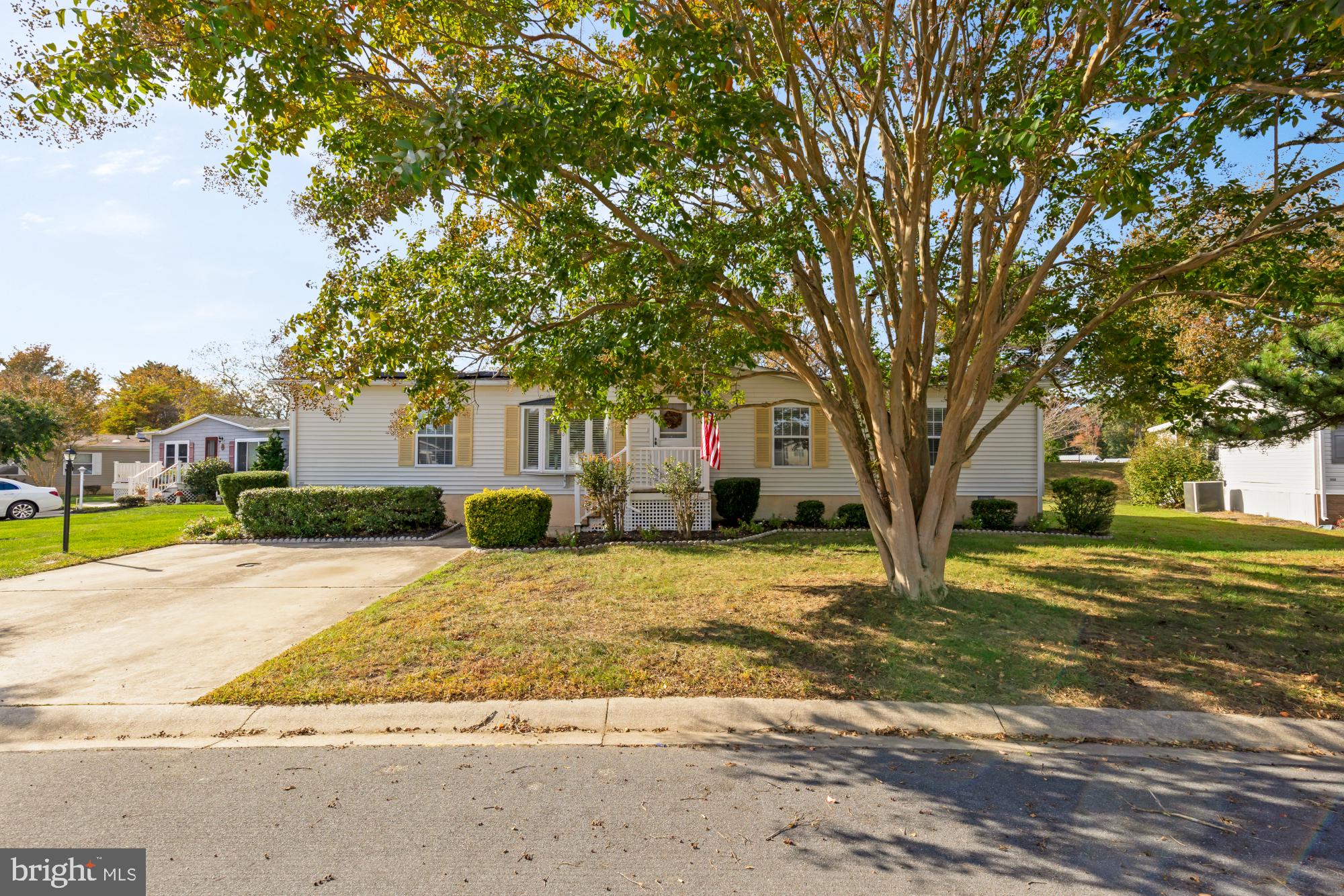Welcome to this delightful 3-bedroom, 2-bathroom home offering over 1,800 square feet of thoughtfully designed living space. Brimming with charm and functionality, this coastal retreat features two inviting living areas plus a generously sized sunroom—perfect for entertaining, relaxing, or creating your ideal flex space. The heart of the home is the bright, open kitchen, showcasing crisp white cabinetry, granite countertops, and plenty of workspace for your inner chef. The rear living room is a true showstopper, complete with a pitched ceiling and a cozy whitewashed brick fireplace that adds warmth and character. The home maintains separation of space with the primary suite on one side while the secondary bedrooms reside on the opposite side of the home. Enjoy a truly carefree lifestyle in this amenity-rich community where lawn care, trash, and snow removal are all handled for you. Spend your free time at the community pool, on the sport court, or on the beach as this home is Located just minutes from grocery stores, restaurants, local bars, and the coastal attractions of downtown Ocean City—plus easy access to boating and fishing—this home offers the best of low-maintenance living in a prime location.
