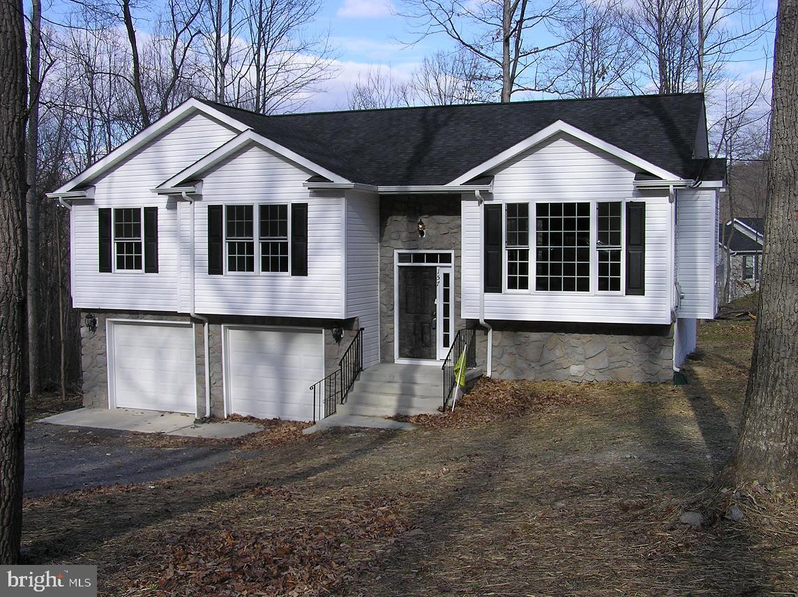 Close in less than 60 days from ratified contract! Enjoy beautiful sunrises AND sunsets, winter views from this nearly 1,700 square foot split foyer under construction now!  See VAWR2006046 for another model for sale on adjacent lot for $399,999. TURNKEY new construction–close when the house is complete (scheduled for closing by the end of the year)-act now to choose options including color of siding,roof,cabinets,flooring,counters,etc! Amazing builder makes new construction fun-listing agent has sold over a dozen to thrilled buyers. This is UNDER CONSTRUCTION NOW–buyers have a chance to customize features/choose colors/upgrade, but this home is already extremely upgraded with upgraded shaker style cabinets and granite counters (in kitchen and bathrooms), 16x12 rear deck, vinyl plank flooring in LR/DR/Kitchen/Hall and porcelain tile in bathrooms and foyer! Nestled on almost 3/4 acre in a dream location (near a wildlife management area with hiking, mountain biking, Appalachian trail access, 1.5 miles from lovely winery–high speed internet is available).  This spacious home offers an open vaulted kitchen/dining/great room, stainless appliances (side by side fridge w/ water & ice in door, smooth top range), master bedroom with private bathroom, roomy guest bedrooms, ceiling fans in great room and all bedrooms, satin nickel hardware throughout, oak railing to basement, 2 car garage (with opener), basement with rec room/4th bedroom plus extra full bath, architectural shingles, low-E energy efficient double hung windows (with window sills), four motion detector flood lights, front and rear hose spigots, painted exterior foundation to match siding, hydroseeded lawn and more! SEE VIEW DOCS on the listing for SO MUCH info about the area and the home (including floorplan)  Enjoy the many recreation areas of SHENANDOAH FARMS:  Farms Riverview Boat Landing ● Farms River Road Rec Lot ● Lake of the Clouds ● Spring Lake ● Shenandoah River Lane Rec Lot ● Treasure Island ● John “Junior” Shipe Park ● Venus Branch Bus Stop Park ● Shenandoah Farms Community Center--No construction loan needed! 100% financing available! Extended rate lock/buydowns available-call for info on local lender with grant access! Ask for builder info/spec sheet/upgrade costs/floor plan, etc--builders are great, experienced and willing to customize.  Call agent for glowing references from the happy 13 buyers and agents we just closed with--these builders are FANTASTIC! Happy to set up a ZOOM call to "meet" builders!