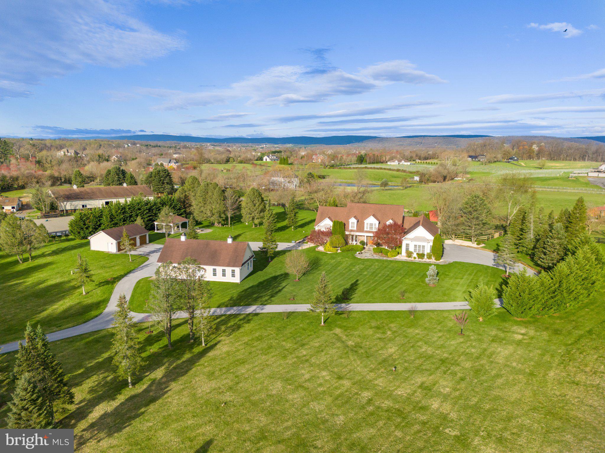 Prepare to be blown away as we unveil the extraordinary 15901 Hampton Rd in Hamilton VA. This property is the epitome of perfection, offering everything you could possibly desire. Whether you're seeking main level living, a multi-generational setup, a poolside oasis, or a haven for car enthusiasts, this home has it all!

Step into luxury with the Main Level Primary Suite, boasting hardwood floors, dual walk-in closets equipped with custom closet systems, and a lavish spa-like bathroom featuring heated floors and a digital steam shower.

Indulge your culinary fantasies in the recently renovated kitchen by Stonegate Construction. This culinary masterpiece boasts top-of-the-line finishes, including custom cabinetry with inset doors and drawers, exquisite quartz countertops, and an appliance package that would make any chef weak in the knees. With Thermador appliances such as a 60” 6-burner gas stove with a 2-burner induction cooktop, Steam wall oven, 48” built-in refrigerator/freezer, built-in icemaker, 2 dishwashers, and a built-in beverage center, this kitchen is a dream come true. The expansive island is perfect for entertaining and is simply stunning. And let's not forget the spacious walk-in pantry!

The light-filled family room features a vaulted ceiling and cathedral windows, creating the perfect ambiance for gatherings. Meanwhile, the sunroom is equally charming with its wood ceiling, skylights with remote-controlled blinds, and panoramic views of the mountains, pool, and tranquil waterfall.

Upstairs, you'll find two generously sized bedrooms, each with updated en suite bathrooms and hardwood floors. The lower level offers a 4th bedroom with a separate exterior entrance, ideal for an au pair or in-law suite. Additionally, the fully finished basement includes a large rec room, convenient bar with another refrigerator, and a versatile flex space that walks out.

Outside, multiple Trex-type decks and patios beckon you to enjoy the saltwater pool and swim spa/hot tub. This home is designed for outdoor entertainment and fun!

If that wasn't enough, car enthusiasts will rejoice at the 3 car attached side load garage, complemented by an additional 3 car detached garage and a 2 car detached garage with a separate contemporary 1 bedroom apartment. That's a total of 8 garage spaces!

Conveniently located in Hamilton, this home offers easy access to major commuting routes, Dulles International Airport, and the plethora of shopping, dining, and amenities that Loudoun County has to offer.

Prepare to be wowed by 15901 Hampton Rd – it's more than just a home; it's a lifestyle!