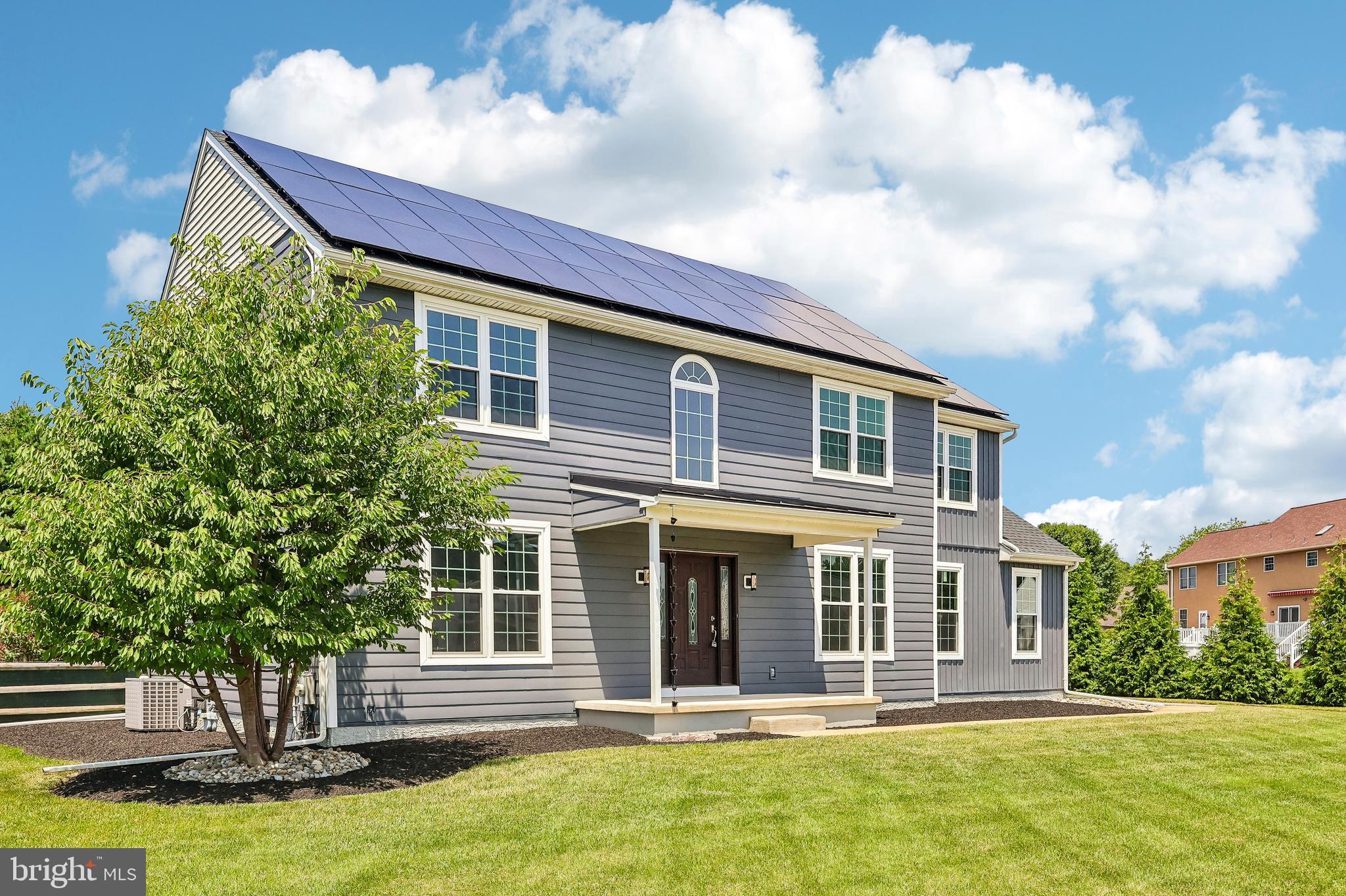 Welcome to this beautifully updated 4-bedroom, 2.5-bath colonial offering the perfect combination of modern finishes, generous living space, and a private backyard setting. From the moment you arrive, you'll appreciate the home's impressive curb appeal, highlighted by a covered front porch and owned solar panels for added energy efficiency.

Inside, you'll find luxury vinyl plank flooring throughout the main level, abundant natural light, and an open, inviting floor plan. The spacious kitchen features white shaker cabinetry, subway tile backsplash, stainless steel appliances, ample counter space, and a large pantry. The adjoining breakfast area opens directly to the expansive concrete patio, creating an ideal space for everyday living and entertaining.

The family room is warm and welcoming with oversized windows, decorative wainscoting, and a striking marble accent wall that serves as a beautiful focal point. Formal living and dining spaces provide flexibility for entertaining, a home office, or additional gathering areas.

Step outside to enjoy the oversized patio overlooking a level, fully usable backyard with mature landscaping that provides exceptional privacy—perfect for outdoor dining, relaxing, or hosting friends and family.