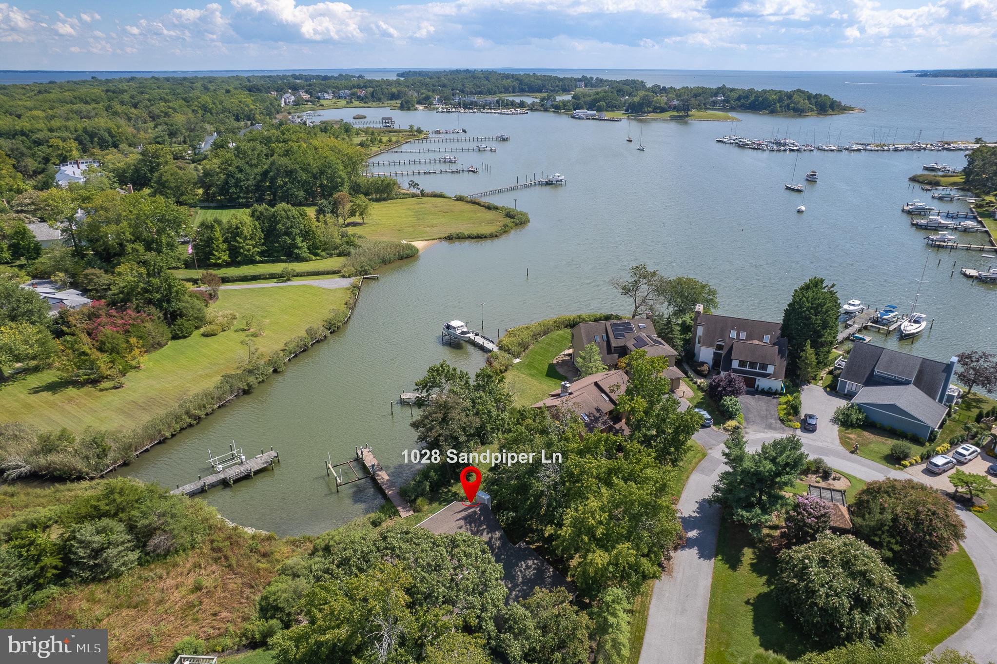 Stunning Waterfront Home with Private Pier and Direct Access to the Chesapeake Bay! This beautiful waterfront property is one of only 16 homes in the exclusive Quay Harbor community. Residents enjoy amenities like a tennis/pickleball court, overflow parking, a central gazebo, and a private, tree-lined entrance.  The home offers tranquil water views and a private pier equipped with a 12,500 lb boat lift, water, and electricity—just minutes by boat from downtown Annapolis. Lovingly updated by its current owners, this home perfectly blends comfort, quality, and coastal charm.  Key Features Include:  
Hardiplank siding and a 2-car garage, New Carrier Infinity Series 4-ton heat pump (2024), Brazilian Cherry hardwood floors and remodeled baths, Updated kitchen with water views and stainless steel appliances, including a double wall oven, microwave, warming drawer, gas cooktop, dishwasher, and a reverse osmosis system for drinking water.  Kitchen opens to a relaxing deck with an awning, perfect for enjoying water views.   Family room with gas fireplace and water views and deck access!  Two-story foyer and open living and dining rooms! Convenient main-level laundry room! Upstairs, the spacious owner’s suite features vaulted ceilings, a walk-in closet, an updated bath, and additional storage. Start your mornings on the private waterfront coffee deck—an ideal spot to watch the sunrise.  The home is fee simple and seller maintains home, yard, and pier.  Condo association maintains road, sewer, tennis courts, extra parking and gazebo.  Nestled on a quiet cul-de-sac in a picturesque community, this home offers the perfect combination of peaceful living and easy access to all that Annapolis has to offer.  Convenient to Baltimore, Washington DC, Ft. Meade, and Andrews AFB too!