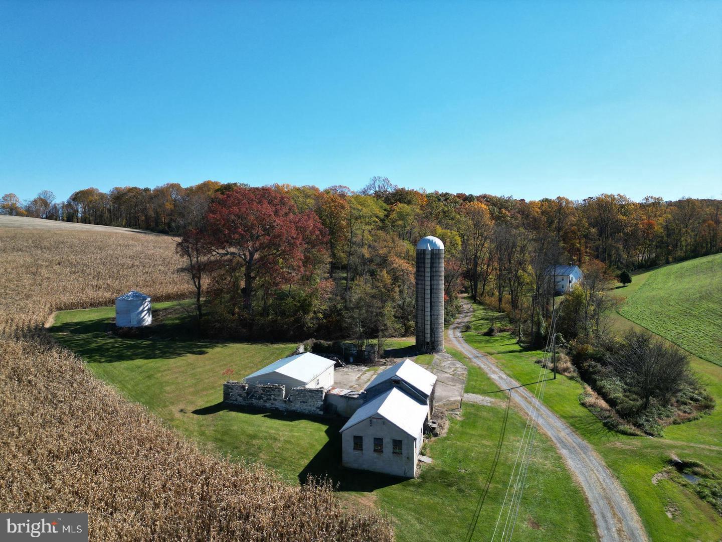 Welcome to this expansive 180+ acre farm offering endless possibilities! This remarkable property features two charming homes! A tranquil creek winds through the land, enhancing its natural beauty, along with a historic spring house that adds timeless character. Enjoy mature trees, multiple outbuildings for storage or farming equipment, and garages perfect for vehicles, workshops, or hobbies. Whether you’re looking to farm, explore the outdoors, or create your own private retreat, this property offers the space, versatility, and potential to bring your vision to life.