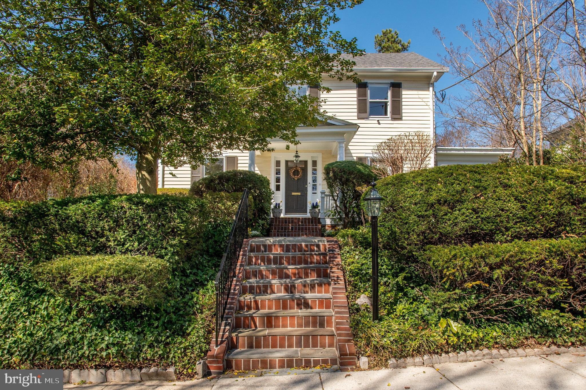 New Price Improvement! This beautifully updated and expanded center hall colonial blends historic charm with modern updates and offers a fantastic spacious floor plan. Perfectly situated in an ideal Chevy Chase location, just a short walk to Bethesda’s vibrant shops, restaurants, and highly rated schools like BCC High School and Chevy Chase Elementary, it provides both convenience and character. The sun-filled interior features lovely hardwood floors, crown moldings, and custom built-ins throughout. A charming front portico and welcoming foyer set the stage for the rest of the home. The formal living room features custom built-ins and a cozy wood-burning fireplace, creating a warm and inviting atmosphere. A spacious formal dining room with elegant chair rail molding provides the perfect gathering setting. The heart of the home is the eat-in kitchen, complete with a center island with seating, stainless steel appliances, a breakfast nook with a built-in bench, and a built-in desk. Open to the kitchen is the sun-filled family room, which offers an excellent space for relaxation and entertainment. A walk-in pantry and mudroom add to the functionality of the space. A convenient powder room rounds out the main level.
The second level offers three bedrooms and two bathrooms. The primary suite is a true retreat, featuring a renovated bathroom with separate vanities, a jetted soaking tub, a walk-in shower, a water closet, and a dressing room with a private balcony. Enjoy added convenience with an in-suite washer/dryer and ample closet space, including a walk-in closet with additional storage. The third floor features an en-suite bedroom with a walk-in closet and an extra bedroom or office space. The lower level recreation room offers ample space for entertainment or play, with an additional laundry room and storage room. Step outside to the expansive back patio, perfect for outdoor dining and entertaining, overlooking the fenced-in backyard with manicured gardens for privacy and play. The home also features a driveway leading to a detached garage, providing plenty of parking and storage space. Located in the Town of Chevy Chase, this home is just blocks from restaurants, shops, schools, neighborhood parks, playgrounds, and a weekend farmers market. It is also near downtown Bethesda, Metro, and major commuter routes. The Town of Chevy Chase is a municipality and provides snow removal services, trash & recycling, leaf collection, and public safety.