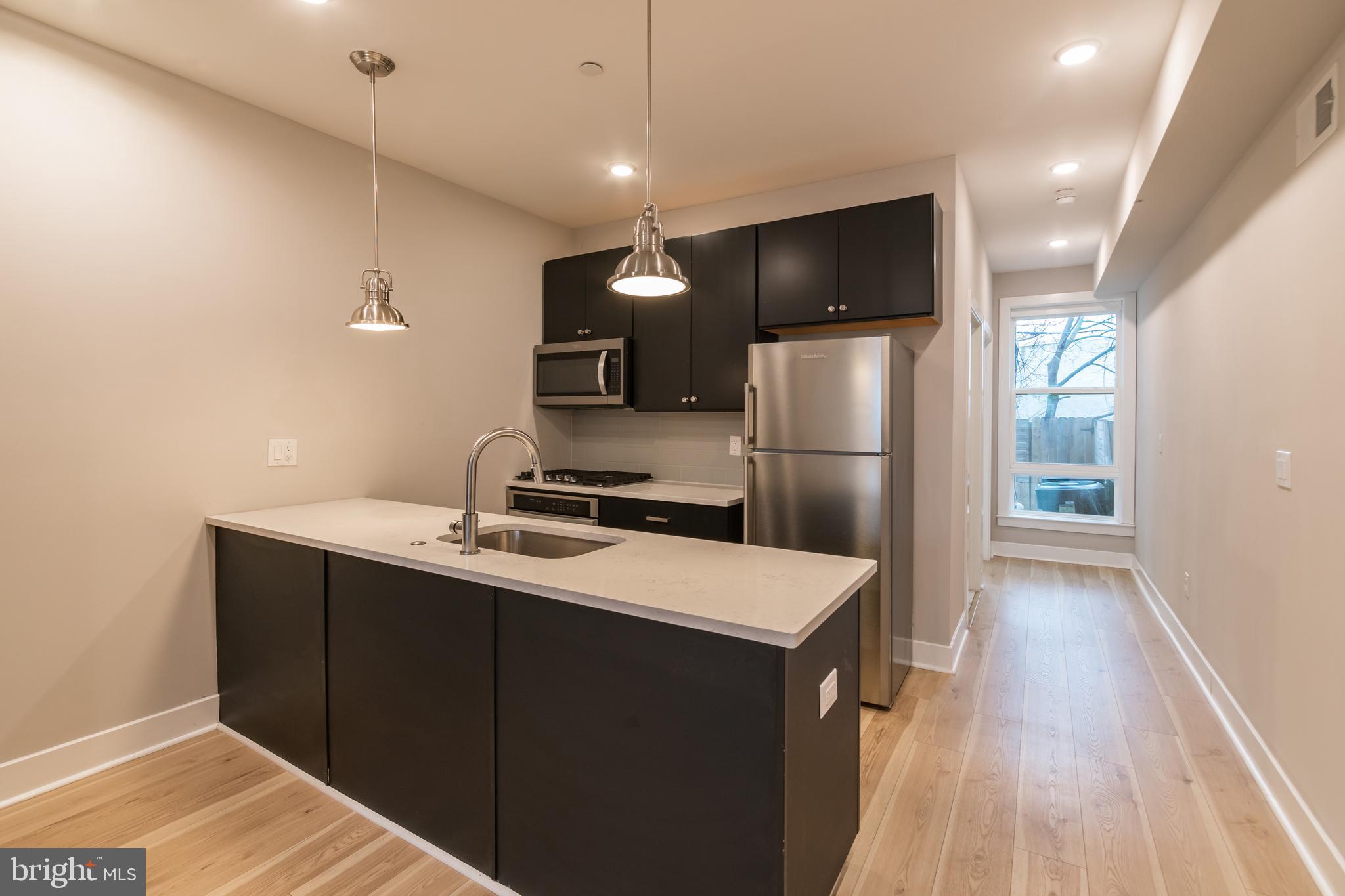 *Available Now!*

A fantastic 2 bedroom, 2 full bathroom apartment in a new construction building with quick access via trolley or bus routes to University City! The first floor includes a spacious open floor plan living room and kitchen with quartz counter tops and breakfast bar, black cabinets and stainless steel appliances. Towards the rear of the apartment is the hall bathroom with a shower/tub and vanity that matches the kitchen. The bedroom includes a large closet and access to the back patio. Downstairs in the finished basement is the washer/dryer, additional communal space for a TV room or home gym, and the second bedroom with an en-suite bathroom and additional access to the back patio. You will also enjoy hardwood floors, central air and recessed lighting!

*Pets permitted – Cat or Dog, subject to owner approval. $500 nonrefundable deposit required.
*Price reflects the net effective rent after a 1.5 month credit is applied to a 18 month lease at $1,465/mo