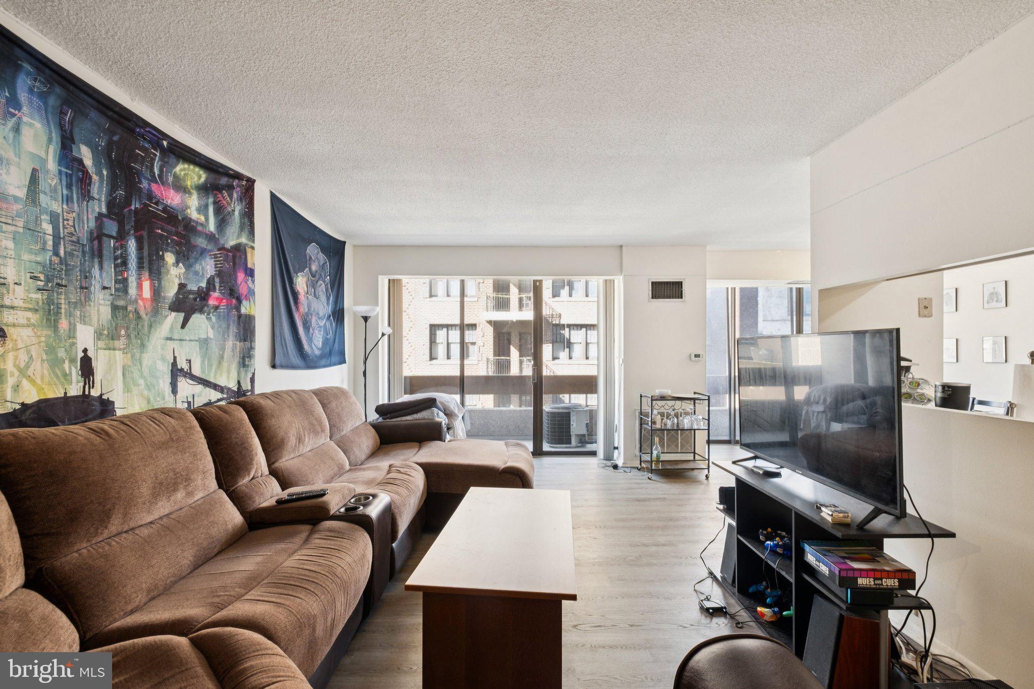 Spacious two bedroom, two bathroom with a balcony at Center City One along the Avenue of the Arts. Boasting city skyline views from all rooms, Unit 703 offers a split open floor plan ideal for both entertaining and everyday living.  Upon entertaining you are welcomed into a large living room with a private balcony. There is an adjacent dining area open to both the living room and kitchen with a Juliet balcony. The kitchen has a very functional layout with its generous cabinet and counter space (image shown of the kitchen is rendering of what it can look like with a minor renovation). The spacious primary bedroom has a walk-in closet and a marble-appointed ensuite bathroom with a stall shower. The second bedroom has a wall of closets, walk-in closet and use of a marble-appointed full hall bathroom with white cabinetry. There is a side by side washer and dryer in the unit. Parking available for purchase in the building for $50,000 for an uncovered spot. Residents of Center City One enjoy a 24 hour doorman, on-site management, an attached parking garage, premium location along the Avenue of the Arts, and the convenience of ground floor retailer including a dry cleaner and convenience store.
