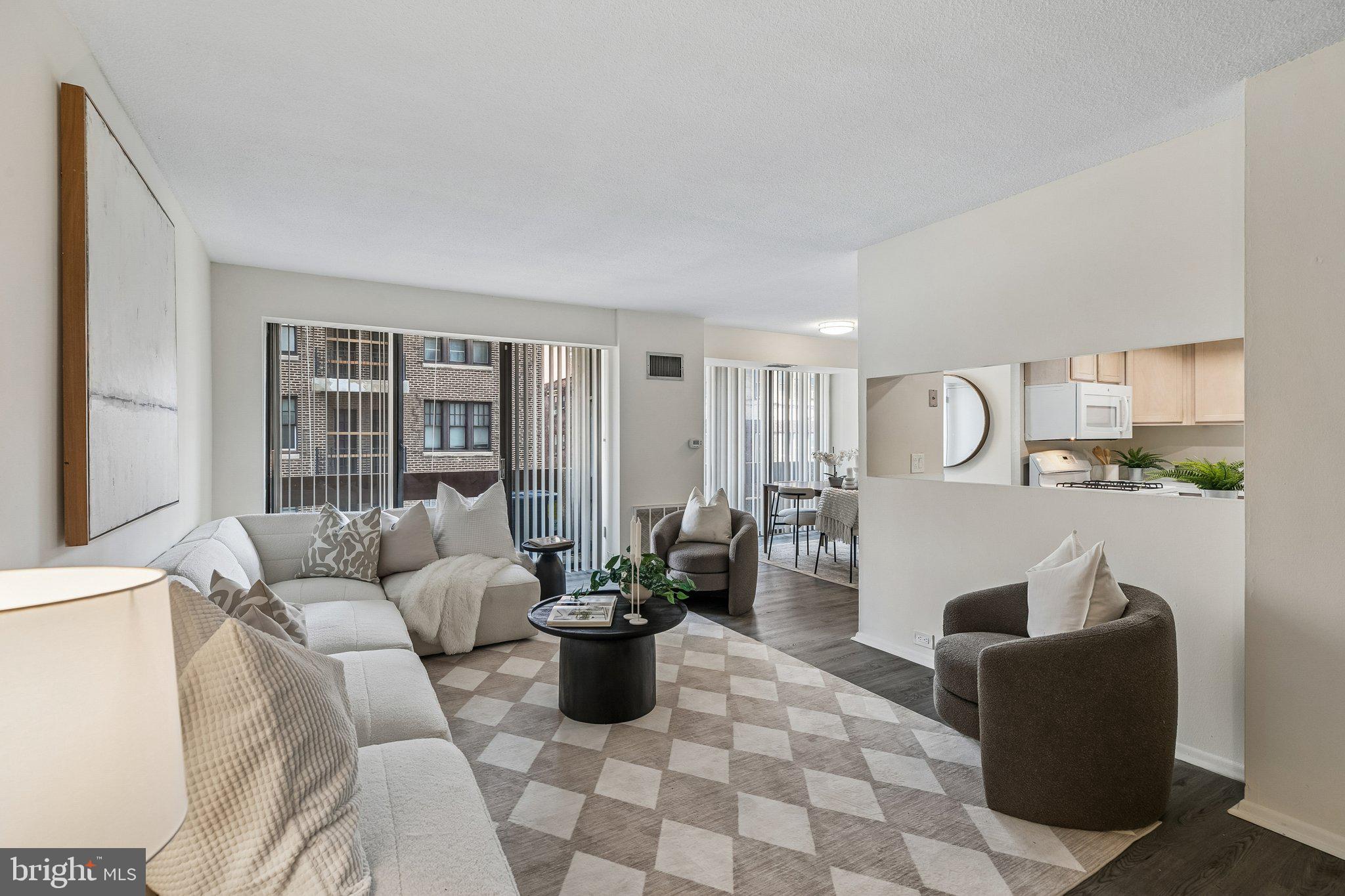 Spacious two bedroom, two bathroom with a balcony at Center City One along the Avenue of the Arts. Boasting city skyline views from all rooms, Unit 703 offers a split open floor plan ideal for both entertaining and everyday living.  Upon entertaining you are welcomed into a large living room with a private balcony. There is an adjacent dining area open to both the living room and kitchen with a Juliet balcony. The kitchen has a very functional layout with its generous cabinet and counter space (image shown of the kitchen is rendering of what it can look like with a minor renovation). The spacious primary bedroom has a walk-in closet and a marble-appointed ensuite bathroom with a stall shower. The second bedroom has a wall of closets, walk-in closet and use of a marble-appointed full hall bathroom with white cabinetry. There is a side by side washer and dryer in the unit. Parking available for purchase in the building for $50,000 for an uncovered spot. Residents of Center City One enjoy a 24 hour doorman, on-site management, an attached parking garage, premium location along the Avenue of the Arts, and the convenience of ground floor retailer including a dry cleaner and convenience store.