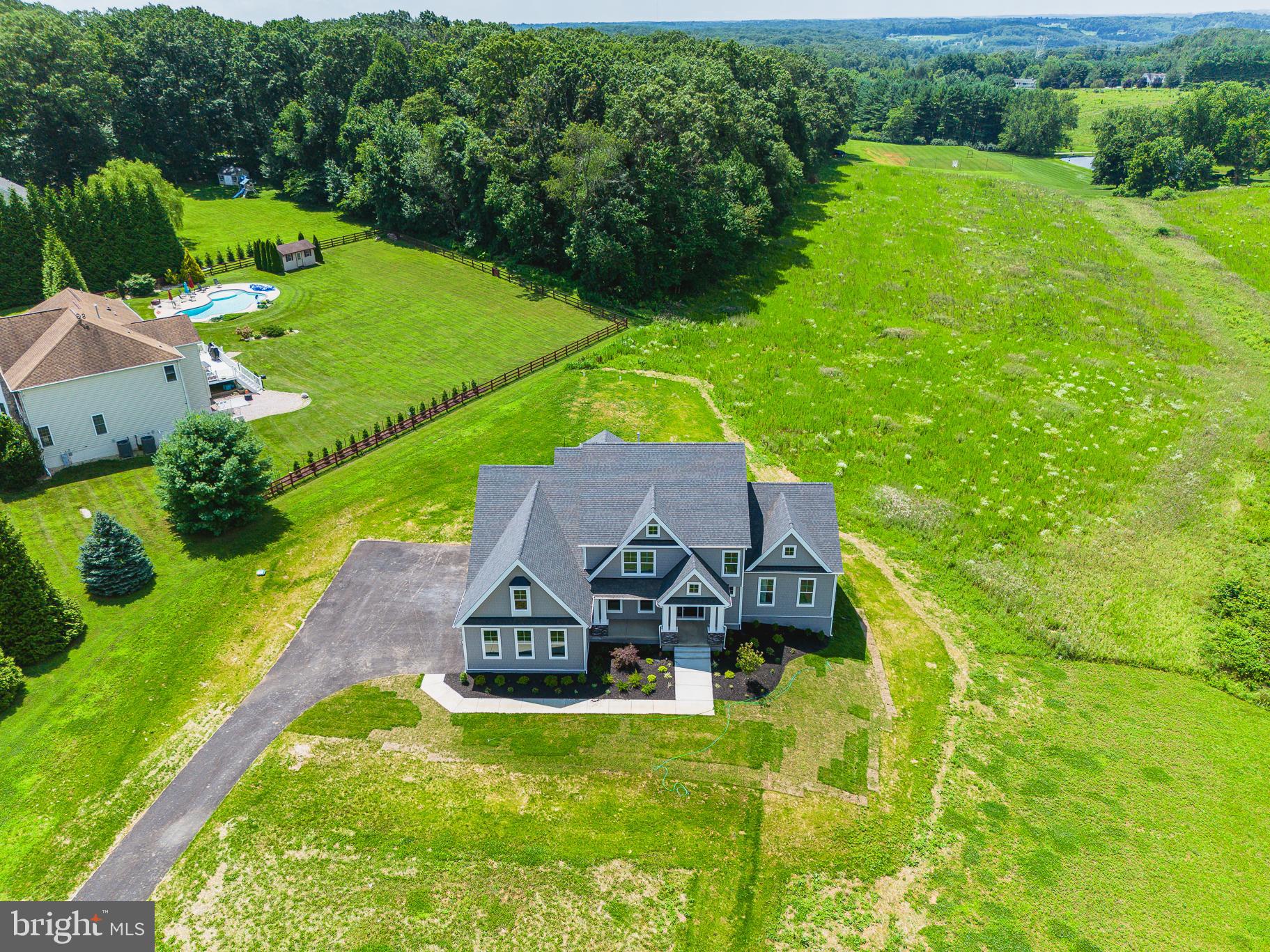 BRAND NEW & READY FOR OCCUPANCY in the sought-after Hereford Zone! Welcome to the Roosevelt III by Greenspring Homes, a thoughtfully designed craftsman-style home set on a private 3.06-acre homesite. This new construction residence combines modern functionality, energy-efficient construction, and peaceful natural surroundings. The main level features a private in-law suite or secondary primary bedroom, a versatile flex room, and an open-concept layout ideal for everyday living and entertaining. The gourmet kitchen showcases a large center island, upgraded cabinetry, premium appliances, farmhouse sink, and expanded pantry, flowing seamlessly into the dining area and family room. A spacious great room and mudroom with built-in cubbies just inside the garage entry provide added convenience. Upstairs, the primary suite offers a large walk-in closet and spa-inspired bath with a dual-entry walk-in shower. Three additional bedrooms, two full baths (jack and jill as well as another ensuite) and an upper-level laundry room complete the second floor. The walkout lower level has a finished rec room and bonus space with plenty of storage. Enjoy outdoor living on the 30' x 14' maintenance-free deck overlooking the private homesite. A three-car side-load garage and expansive driveway provide ample parking and storage. No HOA! More photos of newly finished basement will be posted soon.