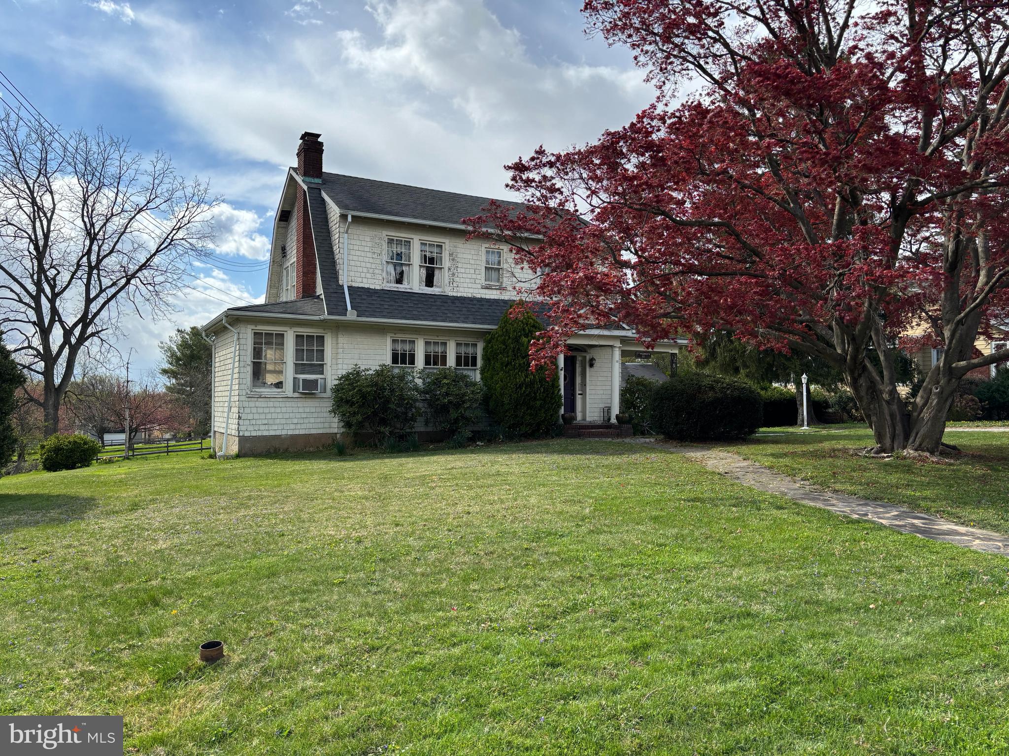 What an amazing opportunity to get into a single-family home in a great location!! This custom-built home is in the American Foursquare style, with Dutch Colonial Revival influences, and has so much charm! It has been lovingly cared for over many years by only two owners and it is ready for its third. Walk into the home's side porch and you are in a lovely, spacious foyer. You'll immediately notice the beautiful patterned wood floors, arches, and ornate wood staircase. The foyer leads into a generous family room with fireplace, which offers ample space to entertain and spend family evenings together. At the end of the house you'll find an office, with features ample light and a cozy spot to get work done. Or continue through the family room and you'll find a large dining room, also with lots of natural light. This flows into the kitchen. Behind the kitchen a full bath has been added, so there is a full bath on both of the main floors. Head upstairs and you'll find four bedrooms and a full bath, and up another level there is a roomy attic that could be insulated and made into additional living space. Back on the main floor, there is a rear entrance that leads into the back mudroom  from the backyard, and there are steps down to the unfinished basement, which offers lots of space for storage. The lot is roomy, almost half an acre, and has plenty of space to play or garden or relax. The backyard also has a detached garage perfect for storing lawn tools and the like. You'll be close to all sorts of shopping and dining in Glyndon and Reisterstown, and can also quickly go north to Hampstead and Westminster, or south to Owings Mills and Baltimore, from this location. Showings will be extremely limited, on May 3 and 4 initially, so please make plans to come see it then!

(The home is being sold "as is", as the sellers are elderly and are unable to make any repairs).