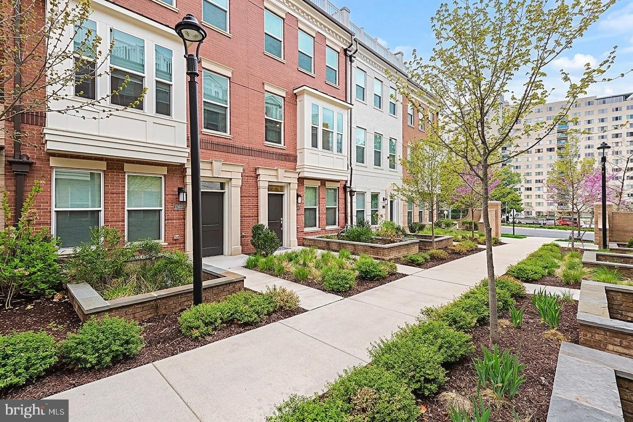 Moments from the Grosvenor-Strathmore Metro, this luxury 4-level brick townhome offers refined living, smart features, and effortless North Bethesda convenience. Thoughtfully designed and virtually staged, it is truly move-in ready in the sought-after Townes at Grosvenor Place.

PRIVATE ELEVATOR & CARPET-FREE LIVING
A private elevator services all four levels, and wide plank hickory hardwood floors run throughout the home.

VERSATILE LAYOUT
The entry level includes a bedroom with ensuite bath, perfect for guests, a home office, or multigenerational living.

BRIGHT MAIN LEVEL
An open-concept main level features abundant natural light, 9-foot ceilings, refined moldings, gas fireplace, and continuous hardwood flooring.

GOURMET KITCHEN
The chef’s kitchen boasts quartz countertops, 42" frameless cabinetry, ceramic backsplash, under-cabinet lighting, premium smart stainless steel appliances, and a custom banquette with extra pantry storage.

LUXURY BEDROOM LEVELS
The primary suite offers a spa-inspired bath and large walk-in closet, plus an additional ensuite bedroom and convenient laundry with LG smart washer and dryer.

LOFT & ROOFTOP TERRACE
The top-level loft provides a fourth bedroom, full bath, and wet bar rough-in, opening to a spacious rooftop terrace with gas rough-in—ideal for relaxing or entertaining.

SMART & ENERGY-EFFICIENT
Highlights include dual-zone HVAC, LED recessed lighting, custom blinds, Honeywell smart thermostat, smart lock, and enhanced Cat-6 wiring.

PREMIER LOCATION & POOL ACCESS
Enjoy easy access to Bethesda, DC, Rock Creek Park, I-270, and I-495, plus nearby Pike & Rose, Strathmore, Wildwood, and NIH/Walter Reed. Optional pool membership at Grosvenor Park I just across the street offers a perfect summer escape.
