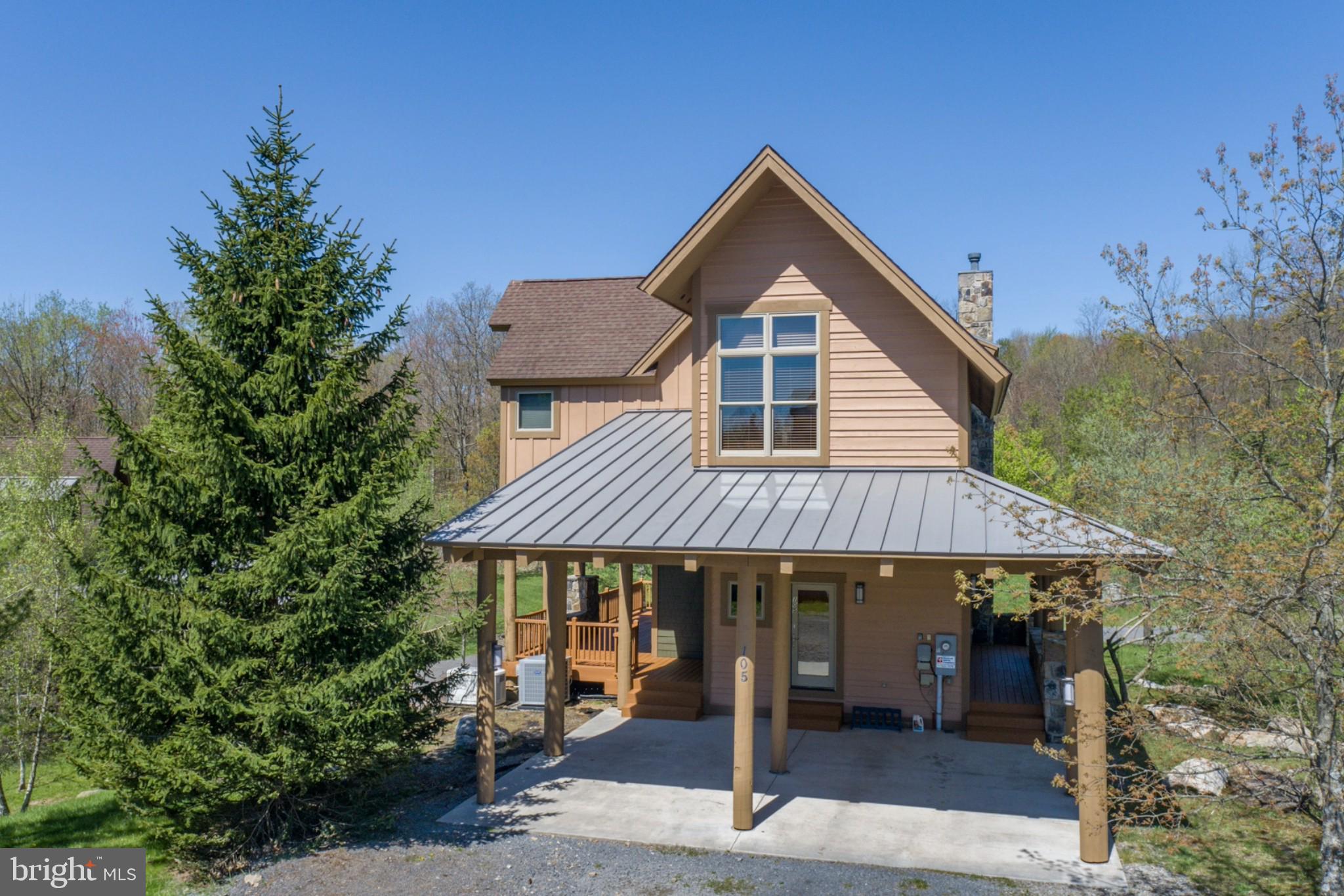 Luxury Mountaintop Ski Chalet with scenic Deep Creek Lake Access for year-round enjoyment. Just minutes from Wisp's ski slopes and ASCI Whitewater, this fantastic location is ideal for exciting summer adventures and winter skiing with effortless connections to the Ski Lodge, easy-access mountaintop ski parking, lift tickets, on-site community amenities, and everything you need. Exceptional craftsmanship and upscale finishes shine throughout this home's bright, open layout designed for entertaining. Unwind by the striking stone fireplace in the inviting living room, while a generous family room and sunlit, flexible loft provide ideal spaces for entertaining, relaxing, or hosting guests. Three bedrooms and 3.5 baths across three beautifully designed levels deliver comfort, privacy, and room to gather. A convenient double carport adds everyday ease for owners and visitors alike. Surrounded by lush, thoughtfully landscaped trees, the setting offers a quiet mountain ambiance with filtered woodland views and a true resort feel. Designed for four-season mountain living, this home offers a high-efficiency HVAC system, architecturally enhanced cylindrical exterior columns, and tastefully updated interior and exterior paint—combining luxury aesthetics with resort-level performance. The home has been carefully maintained over time, reflecting pride of ownership and presenting with the feel often associated with well cared for owner-occupied properties. You'll love the Deep Creek Highlands community, featuring private lakefront access, scenic walking trails, sports courts, playground, and a resort-style outdoor pool with pavilion—ideal for both active adventures and laid-back mountain living. From first tracks at Wisp to summer days at the lake and championship golf at Lodestone, this prime location places every season’s adventure just minutes away, making it a rare and rewarding place to call home.