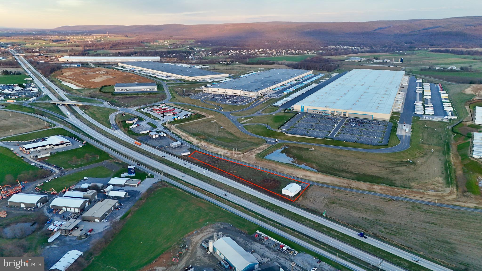 This prime 2.5-acre commercial-industrial land is now for sale, featuring a 4,500 square foot warehouse on-site. The property boasts excellent visibility from I-81, making it an ideal location for a variety of retail and light industrial uses. It is strategically situated near major landmarks, including Walmart and Amazon's expansive distribution centers, as well as Sheetz.

The site is located in a rapidly growing business corridor, making it perfect for enterprises looking to expand. The zoning is flexible, allowing for various development opportunities. The land is easily accessible from Exit 24 of I-81, presenting an exciting opportunity for potential development.