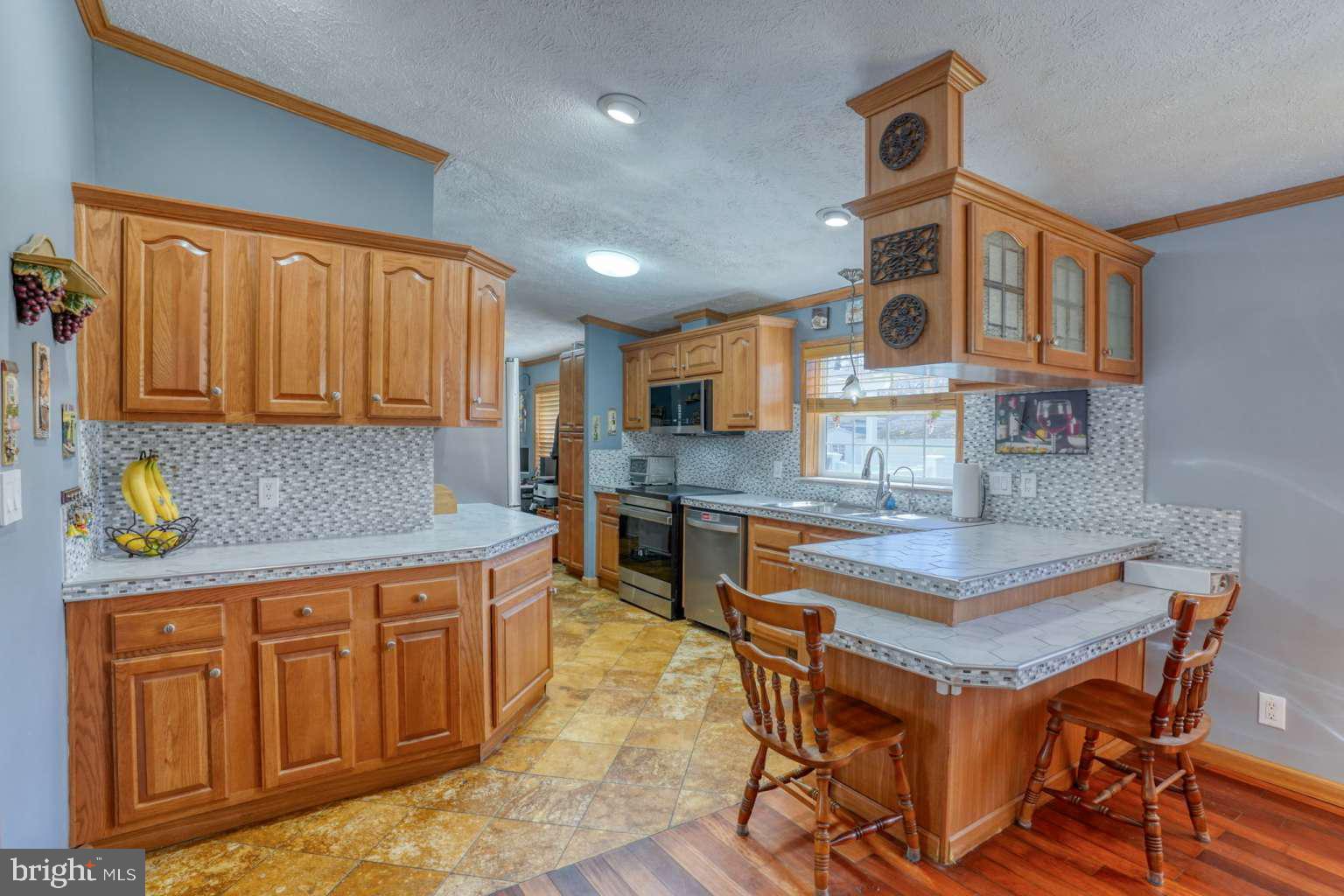 The comfort and convenience of one level living in this spacious home located in the Pot nets Lakeside community which offers residential access to a large community pool. walking trail and a community center with planned events and activities. The floor plan of this home checks all of the boxes including 4 bedrooms, 2 full baths, large living room, dining area, dedicated office space. a large 4 season room, all with hardwood and tile flooring throughout. The kitchen includes updated appliance, loads of cabinets including pantry cabinets, a breakfast peninsula, an adjoining dining area that leads to the living room where a cozy LED fireplace adds ambiance and relaxation. The primary bath includes an upgraded shower and 2 separate glass top vanities. The second bath includes and ungraded walk-in tub for convenience and accessibility. The outdoor space includes a front and rear deck with a hot tub for winging down after a long day of fun! Homes in this area sell from $150/ sq ft -$205/sq ft this home is price to sell at $119/sq ft.