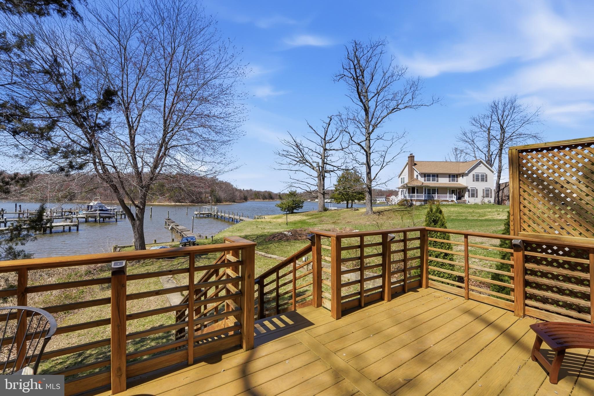 SUMMER GET-AWAY, Perfect vacation home or live here year round, and enjoy all the natural beauty of living on the water on Sue Creek. Take time to relax on the deck and watch the Sunsets directly in front.   You'll want to stay forever, perhaps take a boatride or row in the calm water.  Great home with new Cherry wood kitchen, plenty of cabinet space. Nice dining area, with view to the waterfront. Living room with hardwood floors, and access to the deck. Fully functional lower level has been improved with space for office with built in shelving, and cabinet space. Outside, you'll find the natural secluded deck, with views to the sandy shore, and a walkway, to the water, Launch  your Jet Ski, or john boat.     Structure of home: Solid 8" Masonry walls to roof peak.  Applied insulation and vinyl siding to exterior.  Stainless appliances.
AC unit: Forced-air system; independent duct work from heating system. Located in roof eaves.
Electrical: New service upgrade February 2026. 150 AMP with surge protection added. Close to all major waterfront restaurants, Charleys marina & tiki bar, LunaSea, the Middle River Yacht club, Carsons' Creek seafood restaurant. 10 minutes from Middle River. Easy care home, lots of mature plants and trees, landscaping done by Owner, or  just put in your Kayak.