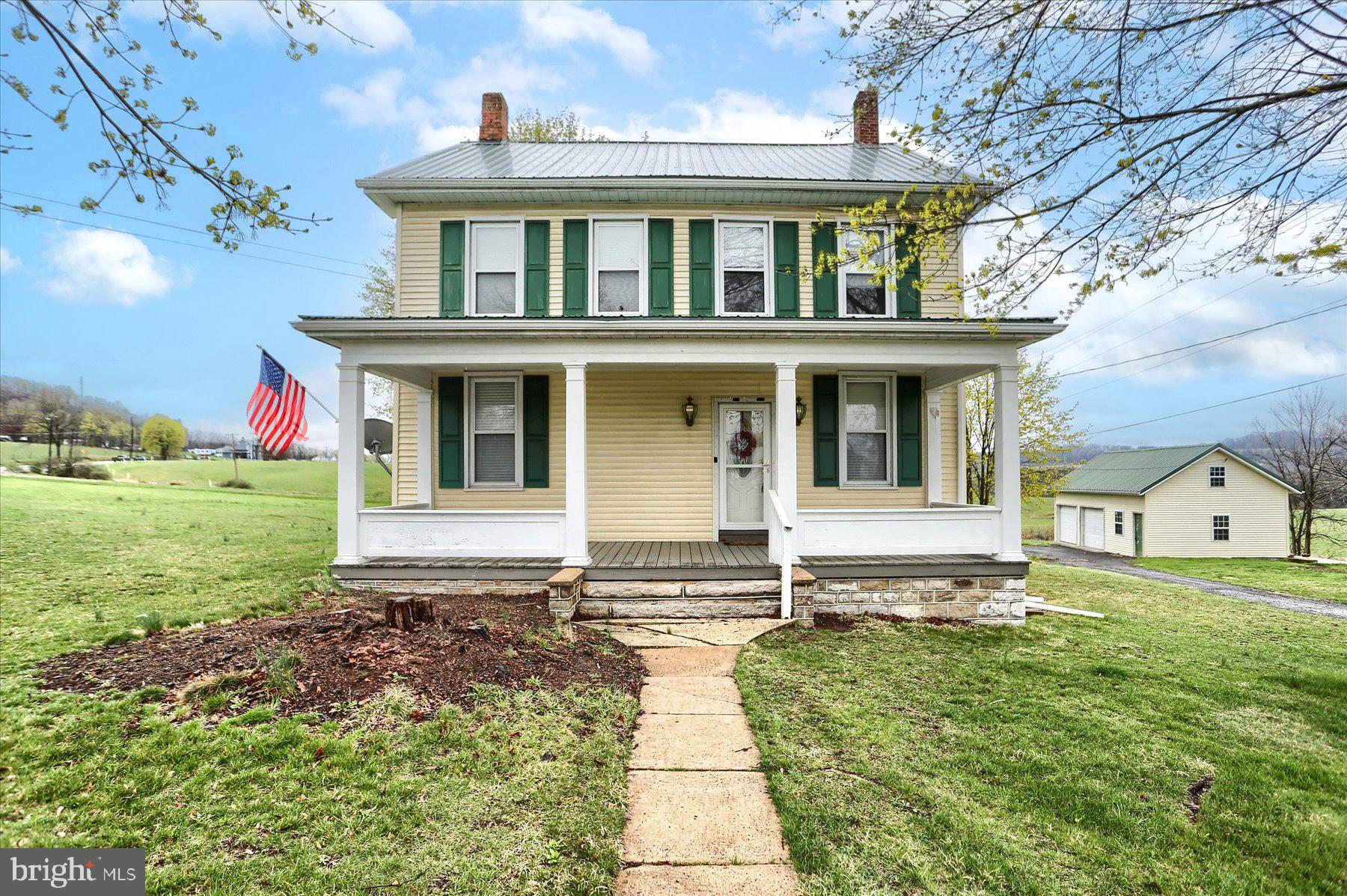 Spacious home and country living! You are close to schools and community park, there is so much to love about this home. It has been cared for and enjoyed for so many years and now is the time to make your memories here.  You can sit and relax on the large covered porch at the end of the day or start the day with a cup of tea or coffee. The bath was remodeled in 2022 and there is a walk in closet on the second floor. In addition to the covered front porch there is an enclosed 10x6 rear porch.  For the cook in the family there is an island in the kitchen. There are hardwood floors and we believe hardwood under the existing carpet that is a couple of the rooms. A walk up attic means more storage as does the storage/workshop above the two car garage. The water conditioning system is owned not leased. The wardrobe in the 2nd floor BR will remain. ALL OFFERS MUST BE SUBMITTED BY APRIL 13TH AT NOON.