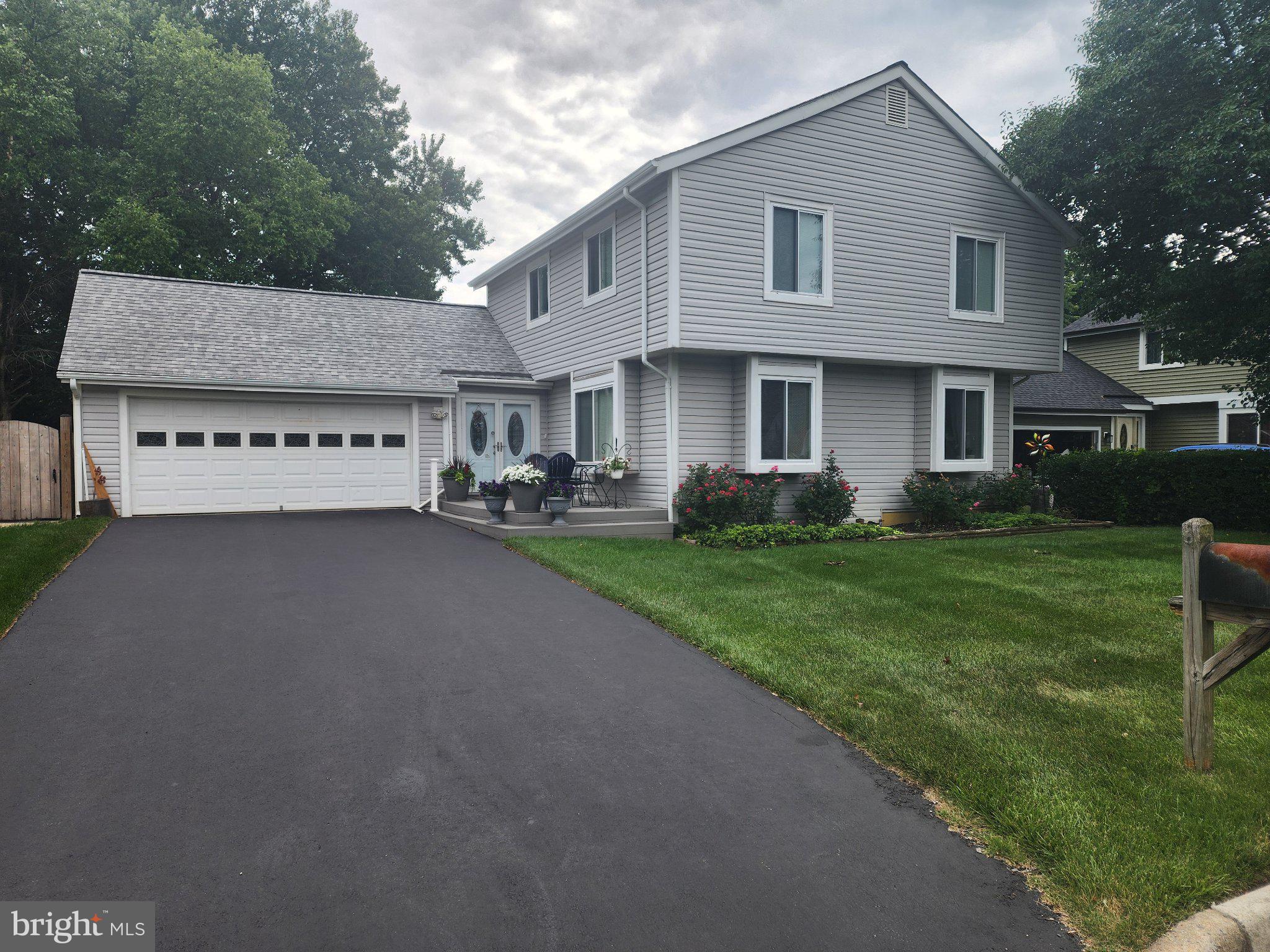 Professional photos will be posted soon. OPEN HOUSE SUNDAY, 6/21 12pm - 2pm. Beautiful curb appeal! Gorgeous home has 2076 finished sf with two car garage includes lots additional storage. Brazilian cherry hardwood flooring on the main level shines as you walk into the double door entry way. Upstairs has 4 bedrooms and 2 updated baths.  Primary bedroom has private bathroom with walk-in shower. Updated eat-in kitchen with stainless appliances has direct access to the deck through a sliding glass door. Separate dining room leads to living room with two large windows. Large spacious family room with vaulted ceilings has a gas fireplace flanked by white custom shelving has a slider that leads to spacious deck that offers a retractable awning providing protection from the sun. Fenced backyard has beautiful lawn, flower beds and shed.  Laundry room is on the main level with lots of storage. All of this and a full unfinished basement. An additional 500sf to make into additional living space. HVAC replaced 2022. Water heater less than 5 years. This home well cared for and updated. Current owners have lived here over 30 years. It is being sold AS-IS condition.