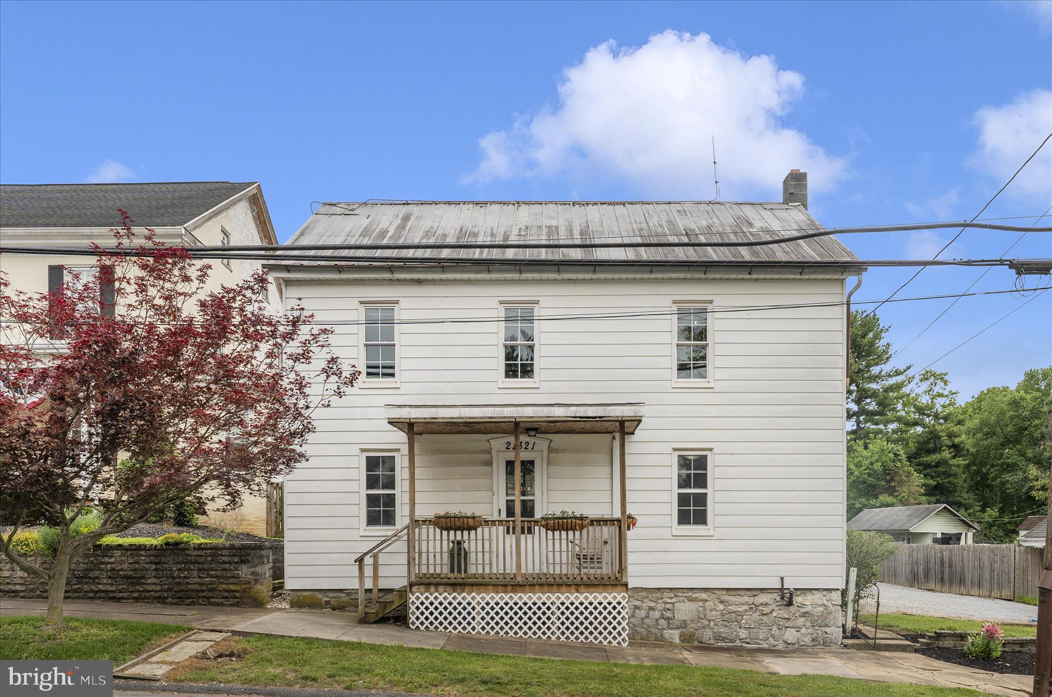 Welcome Home to This Charming Circa-1883 Farmhouse in the Highly Desired Smithsburg School District! Nestled on over a 1/3 of an acre lot in a peaceful setting just outside Smithsburg yet conveniently located in Leitersburg. This beautifully updated farmhouse offers the perfect blend of timeless character and modern comfort. With almost 1,900 finished square feet, this spacious home is filled with warmth, charm, and thoughtful updates throughout. The inviting main level features an open kitchen that flows seamlessly into the dining room and living area—ideal for both everyday living and entertaining. A versatile den (or potential main-level bedroom) includes a full bath, providing flexible living options. A convenient mudroom and  laundry area add to the home's functionality. Upstairs, you’ll find four generously sized 4 bedrooms and a full bath featuring a double vanity. Fresh paint throughout enhances the bright, welcoming feel of the home. Cozy up in the living room by the wood stove on cooler evenings or step outside to enjoy the large patios—perfect for grilling and relaxing. The spacious backyard offers plenty of room to play and unwind, complete with 2 sheds and a woodshed, a charming playhouse, partially fenced, and ample parking. The roof will also be sealed and painted before settlement. There is a huge attic for storage. Located just minutes from shopping, dining, golf courses, fishing spots, and major commuter routes including I-70 and I-81, this home truly has it all—country charm with everyday convenience. Don’t miss your opportunity to own this unique and character-filled farmhouse!