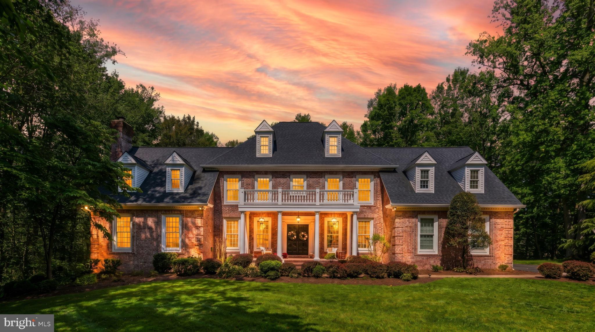 Set in a peaceful, neighborhood cul de sac, on a 3.07-acre lot in the Baltimore County market, this multi-level brick estate balances timeless architecture with substantial, modern capital improvements. Offering approximately 7,300 square feet of finished living space across multiple levels, this 6-bedroom, 7-bathroom property provides a highly functional footprint optimized for comfortable family living, multi-generational flexibility, and effortless entertaining. 

A private driveway leads to the home's commanding brick facade, highlighted by an elevated, columned front porch spanning the front elevation. Recent exterior updates emphasize low-maintenance living and immediate peace of mind.

A new roof has been installed for along with brand new coordinating gutters and downspouts for optimal drainage. All architectural dormers have been professionally wrapped to deliver a sharp look and long-lasting durability against the elements. The rear of the property features a large, elevated deck that looks out over manicured lawns, a dense canopy of mature trees, and the private in-ground pool below.

The interior is defined by an open, bright floor plan with generous expanses of glass that pull natural light deep into the home. The front foyer features warm hardwood floors, classic crown molding, and chair rail details. Elegant pocket doors transition seamlessly into a separate, formal dining room designed for hosting. The heart of the main level centers around a gourmet kitchen featuring upgraded countertops, a breakfast area, stainless steel appliances, and premium cabinetry, flowing naturally into spacious family gathering areas.

The upper levels accommodate a multi-bedroom layout, including a primary bedroom retreat equipped with a spacious master bath and soaking tub. A key modern transformation includes a Secondary Primary Suite. One of the traditional upstairs bedrooms was completely reimagined and re-engineered into a private Secondary Suite. It showcases an expansive, custom-tiled walk-in shower with high-end fixtures—perfect for long-term guests, in-laws, or an upgraded secondary suite. 

The expansive lower level functions as a fully finished recreational hub, featuring a built-in bar, extensive open space for entertainment, and a full bathroom. Flooded with light by matching double windows, this level features two sets of double French doors that step straight out to the in-ground pool area. The design ensures a practical, seamless transition for indoor-outdoor poolside gatherings.

Complete with an attached multi-car garage, premium appliances, and distinct structural updates, 5 Carroll Run Court offers a refined living experience in a quiet Phoenix enclave.