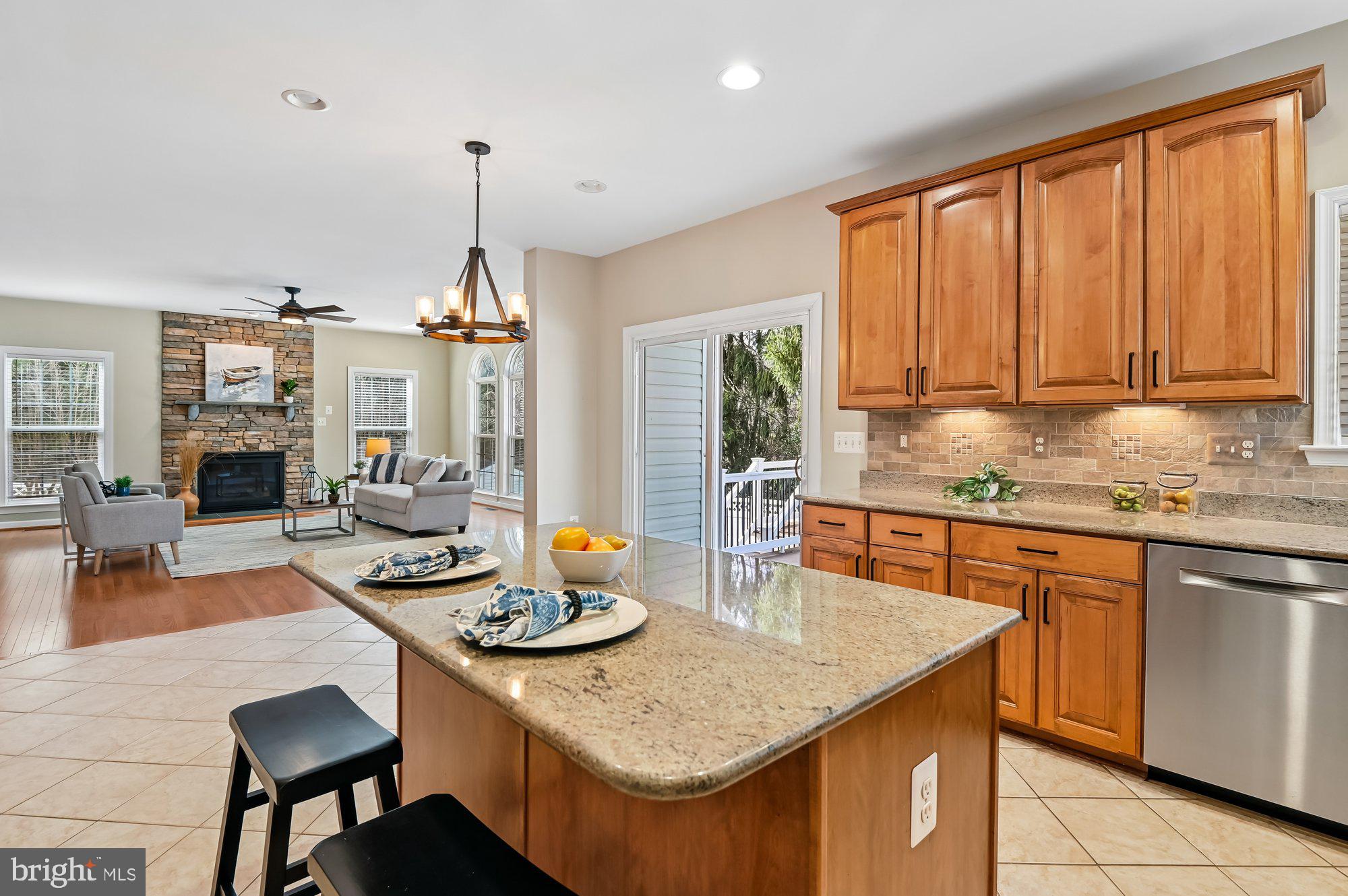 MAJOR PRICE ADJUSTMENT!!!!  Welcome to 614 Crawfords Ridge — Located in a welcoming 55+ community, You CAN BE 48 YEARS OLD with upper TEENAGE CHILDREN!!!
 This home is a beautifully maintained white‑brick Colonial tucked into a quiet cul‑de‑sac, offering over 4,000 sq ft of thoughtful design, natural light, and modern comfort.
Step inside to an open floor plan with hardwood floors throughout, high ceilings, and a warm, inviting fireplace. The large family room flows seamlessly into an updated kitchen featuring gas cooking, granite countertops, abundant counter space, a pantry, an island and a dining area. 
A versatile office space on the main level can easily function as a first‑floor bedroom, complemented by a convenient half bath. Off the back of the home, enjoy brand‑new decking, with Awnings that provide more shade when needed and are perfect for entertaining or relaxing while overlooking peaceful woods for added privacy.
Upstairs, you’ll find four spacious bedrooms and three full baths, including a generous primary suite with double sinks, granite counters, and a beautifully appointed primary bath. The laundry room is thoughtfully located on the bedroom level.
The refinished basement expands the living space with great lighting, fabulous wood floors and a bar with sink, a full bath, and walkout access—perfect for guests, hobbies, or recreation. Also, it offers plenty of storage. 
HVAC's were replaced 2024,  booster pump in 2022 and solar tint on windows that convey to the new owners with a warranty.  There is an irrigation system with a control panel that was replaced in 2024.  The home also includes a dehumidifier for more comfort on those humid Maryland summer days. 
      Located in a welcoming 55+ community, WITH UP TO 20% of residents under the age permitted with RESTRICTIONS-no one under 48 and no children younger than upper teens! The home backs to woods, providing privacy while being close to walking paths and major highways for an easy commute.
A rare blend of space, style, and location—this home is truly move‑in ready.