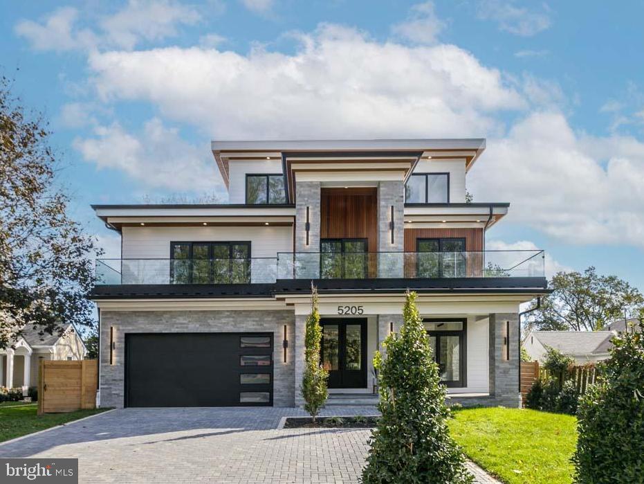 *** Happy Hour Open House 4-6pm Friday & Prosecco Sunday 2-4pm *** You didn't miss out!   This amazing home is back on on the market, but first in this Friday for Happy Hour!   Stunning elegance in this 4-Level, 5BR/5.5BA home with 4 enviable terraces, pavered driveway and lush landscaping.    Glass walls and floating stairs with a versatile floor plan showcasing oversized windows, multiple informal and formal living options, high ceilings, white oak floors, and expert finishes.  Delight in the chef’s kitchen with large, quartz, waterfall center island, JennAir stainless steel appliances, and abundant storage. Get cozy in the living room anchored by a gorgeous gas fireplace.  An office , custom mudroom, walk-in pantry, and convenient powder room complete this level.   Heading up the floating glass stairway to the 2nd floor you’re presented with a sizable ensuite guest room, laundry room , 2 generous bedrooms conjoined by a double-vanity bath. Plus a large front-facing balcony connecting two of bedrooms. The primary sanctuary boasts 2 walk-in closets and a full attached bath with soaking tub, sexy dual sided glass shower, water closet, and double vanity.    The open and airy top level comes equipped with a wet bar, wine fridge, full bath, and offers a great space for guests or an additional entertaining/living space where you can take the party outside to the exceptionally large terrace overlooking the mature tree-line views.
The lower level features a recreation/family room with wet bar and wine fridge,  comfortable bedroom, full double-entry bath, and a yoga/fitness room complete with athletic flooring and mirrored wall. Once again, take your entertaining outside to a covered stone patio overlooking the fully-fenced yard! All of this located in the Whitman School Cluster, blocks to the shops of Sangamore and less than 5 miles to Palisades, Friendship Heights and Bethesda Row Restaurants.