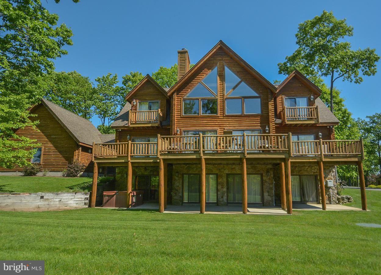 Luxurious Mountaineer Log home with a DOCK SLIP offering 7 bedrooms (3 en suites) and 5.5 baths in the coveted Deep Creek Highlands community atop Wisp Mountain. Highlights of the spacious interior include an open layout, granite counters, multiple gathering areas, and 2 fireplaces. Enjoy outdoor living on the expansive deck or the lower-level patio. A two-car attached garage provides you plenty of storage for winter and summer toys. An added perk is a dock slip at the community’s lake access area just a short drive away. In addition, Deep Creek Highlands has an outdoor pool, tennis court, playground, and walking trails. Less than one mile from the ski slopes and a plethora of area activities, you have the best of Deep Creek at your fingertips! Whether seeking a vacation retreat or a permanent residence, “Colorado Dreamin’”, an established rental, presents an exceptional opportunity.​