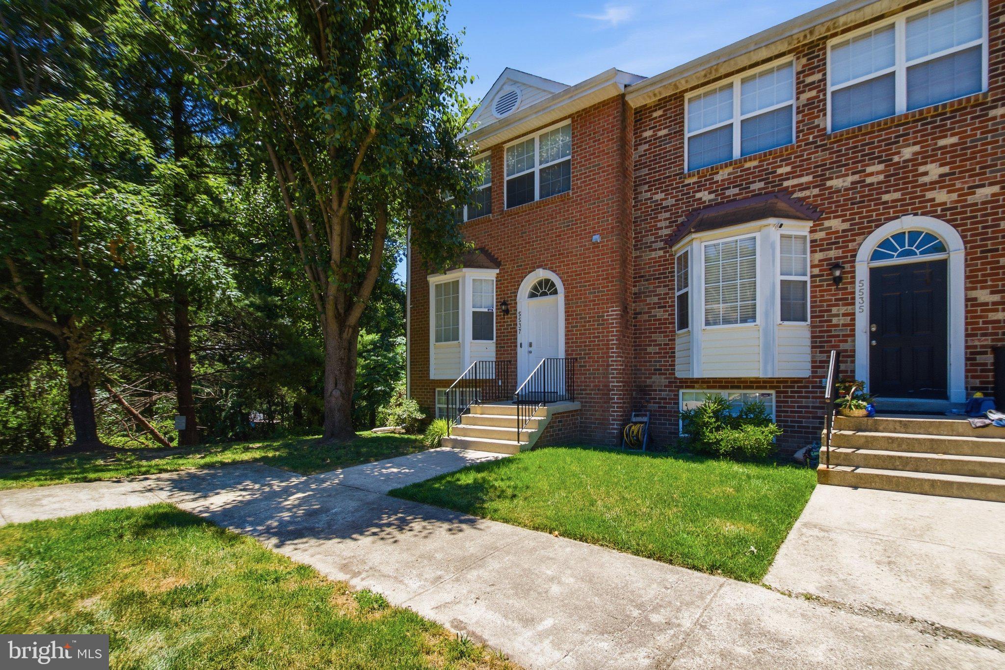 Beautiful end-unit brick-front townhome backing to mature woods offering privacy, nature views, and a highly desirable location.

Step inside to hardwood plank flooring flowing through the foyer, living room, and dining room, creating a warm and cohesive main level. The front kitchen features table space with a bright window view, stainless steel appliances, granite countertops, and tile backsplash—perfect for everyday living and entertaining. A convenient half bath completes the main level.

The upper level offers three well-proportioned bedrooms, including a primary suite with private bath, plus an additional full hall bathroom.

The fully finished lower level expands the living space with a recreation room, an additional bedroom, full bath, and walk-out access to the fenced rear yard—ideal for guests, extended living, or flexible use.

Additional highlights include newer HVAC and hot water heater, generous storage space, and a peaceful setting that backs to wooded parkland.

Location is a standout—walking distance to a large national park featuring a nature center, lake, walking trails, and ball fields, offering a rare blend of convenience and outdoor lifestyle.