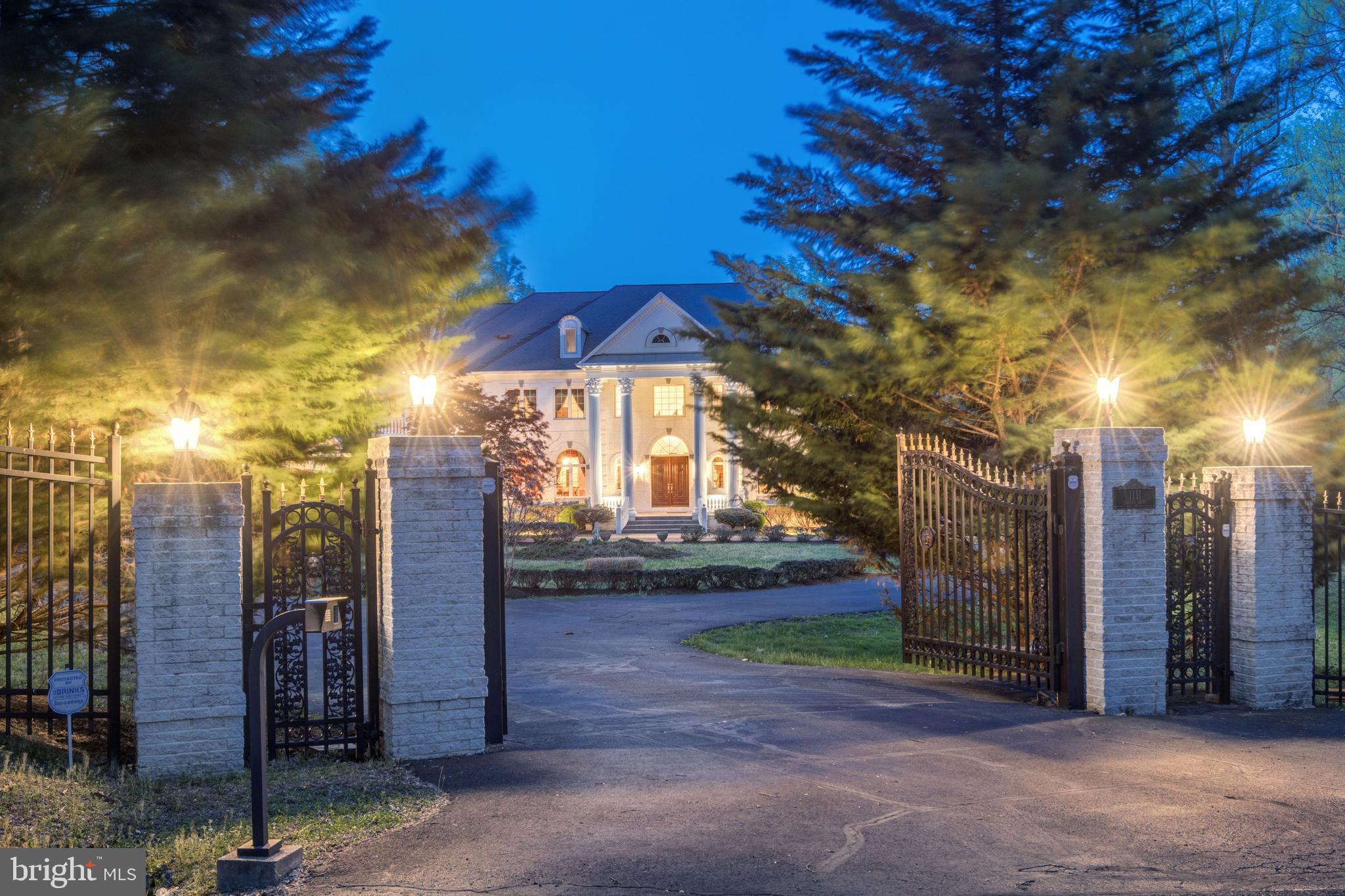Gated Estate nestled on a cul-de-sac with 5 Acres of spectacular vistas. This extraordinary home offers 10,700 square feet of fine living. Two- story Foyer, spacious Formal Rooms, Library with fireplace, Main Level Bedroom, Kitchen with large center island and a separate catering Kitchen. The Great Room has soaring windows and fireplace. The Upper Level boasts two ensuites and two Master Suites with dual walk-in Closets and luxurious Baths. Walk-out Lower Level with Bedroom, Fitness Room, Sauna, Theater, Wet Bar & Kitchenette. Exterior features 4-car Garage, sprawling Terrace, and circular Driveway.