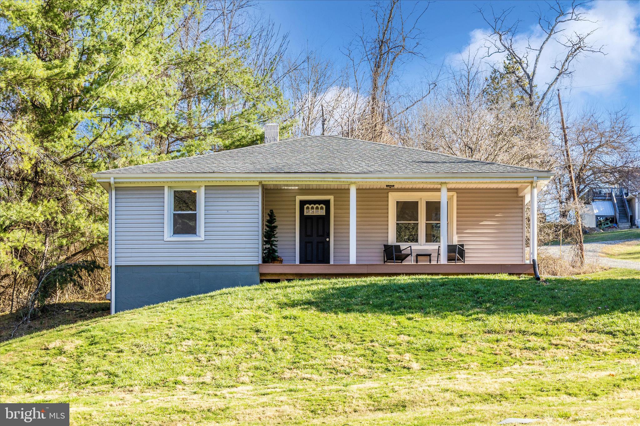 Experience the perfect blend of modern convenience and rural tranquility at 11683 Wolfsville Rd. Situated on an expansive 2.14 acre lot This adorable, fully renovated rancher offers the rare luxury of wide open space paired with seamless one-level living. Inside, you'll find durable LVP flooring throughout the main living areas. The heart of the home is bright, white kitchen with granite countertops, a classic subway title backsplash, and a full stainless steel appliance package. 

Rest east knowing the heavy lifting has already been done, with a newer roof, siding, windows, new septic system (all updated circa 2021). The unfinished walkout lower level offers a blank canvas for a home gym, workshop, or future sitting room. Enjoy the peace of no city taxes while remaining just a short drive from the amenities of Smithsburg!