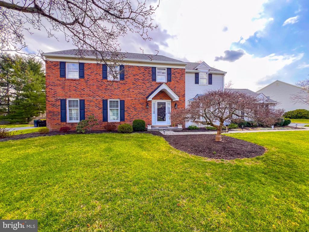 This rarely offered Center Hall Colonial in the desirable Yardley Hunt community boasts stunning curb appeal. A paver walkway leads to the front door, framed by elegant brick facing. Upon entering, you'll be greeted by a grand two-story foyer with a striking turned staircase, flanked by both the spacious formal living room and formal dining room. Beautiful dental moldings add charm to the dining room. The renovated kitchen is a chef's dream, featuring 42-inch off-white cabinetry, coordinating granite countertops, a center island, and a custom pantry. The three-pane kitchen bay window bathes the breakfast room in natural sunlight, creating a warm, inviting atmosphere. The kitchen seamlessly opens to the family room, where a gas fireplace takes center stage. The large, flat, fenced-in backyard is easily accessed from this room, and a retractable awning provides shade on sunny days. An updated powder room, as well as a convenient mud/laundry room, complete the first floor. Upstairs, you'll find three generously sized bedrooms that share an updated full hall bathroom. The sprawling primary suite offers a private sitting room and a newly renovated ensuite bathroom, providing a luxurious retreat. The unfinished basement is ready for your personal touch and offers ample additional storage space. With over 3,000 sq. ft. of living space and most rooms adorned with hardwood flooring, this home offers both style and comfort. Additional features include a 2019 roof, a whole-house generator, and regularly serviced updated systems. Your new home is ready and waiting for you!