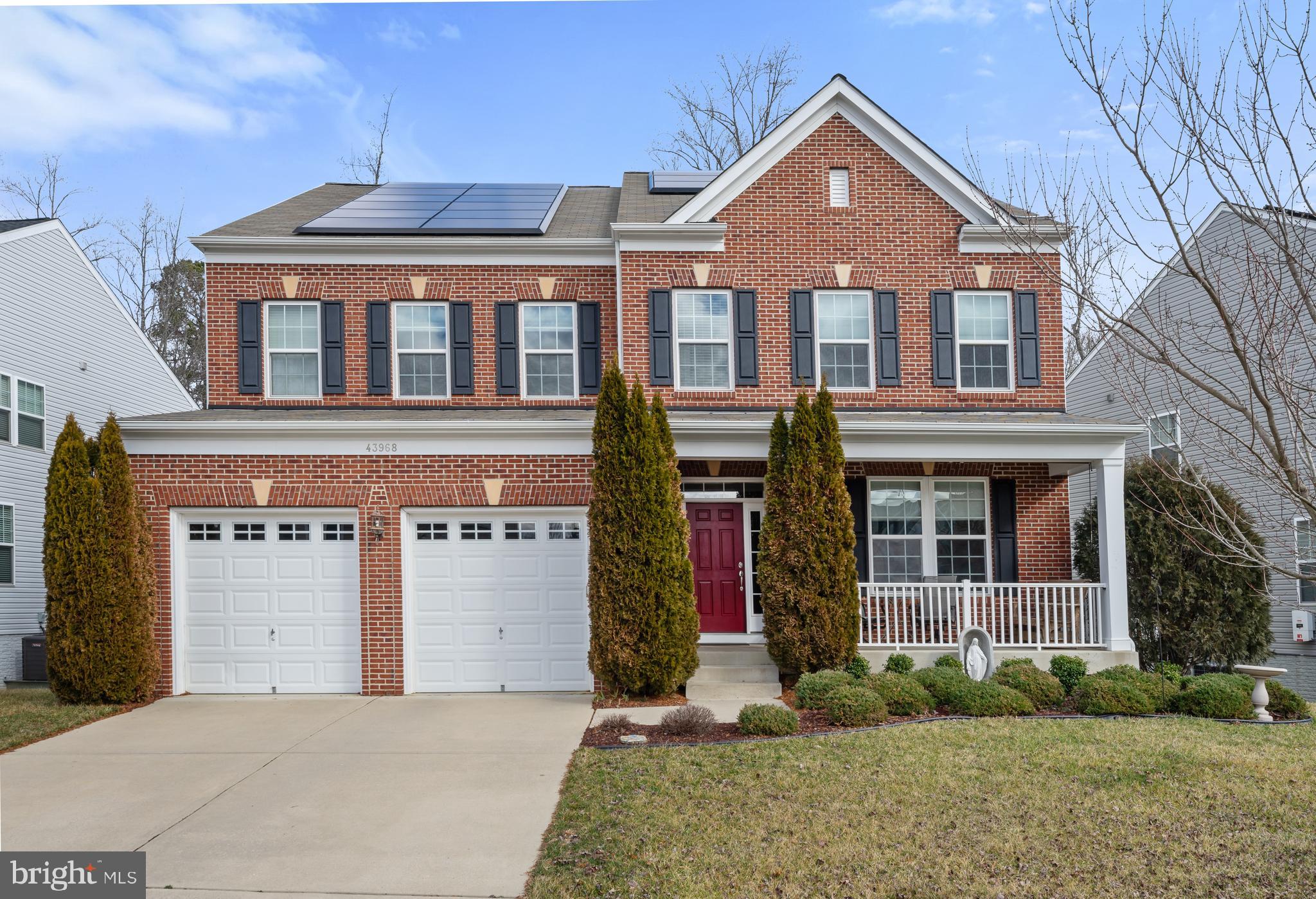 This beautiful Brick Front Colonial is located in Woodland Park at Wildewood.  **ENERGY EFFICIENT**   Outstanding features of this home include TESLA Solar Panels *OWNED* not leased!  TESLA EV Car Charger in Garage.  HOT TUB to unwind on your private rear Trex Deck backing to trees.   Every bedroom of this home offers EN-SUITE BATHS for privacy!
Main Level offers gleaming hardwood floors, an expansive gourmet kitchen with stainless steel appliances, center Island with seating, granite counter tops, upgraded 42" maple cabinetry with crown molding, gas range, pantry, and table space.  A spacious Family Room off kitchen features a gas fireplace with mantel and plenty of seating space for entertaining.   There is also a Formal Dining Room and Living Room currently being used as home office.   Upstairs you will find all Bedrooms include walk-in closets, ceiling fans with lighting,  and en-suite baths.  The Primary bedroom boasts two  expansive walk-in closets, a Luxury bath with soaking tub,  a separate walk-in shower, an extra long dual sink vanity, and gorgeous ceramic tile throughout.  Another bedroom with its own private en-suite bath and two additional bedrooms with their Jack and Jill bath.  Enormous Lower level is complete with plenty of windows letting in the daylight, a walk-out to rear yard,  a rough-in for future bath, with tons of space for rooms and finishes!  Concrete Driveway, Front Load garage with openers, and covered front porch.  Community amenities include: Swimming pools, walking trails, multiple playgrounds, community lake, Clubhouse, tennis courts, cycling lanes and more. Conveniently located near local beaches, parks, shopping, museums, boardwalks, restaurants and theaters. As well as close proximity to Patuxent Naval Air Station (PAX),  Solomons Island, and the Leonardtown Wharf.