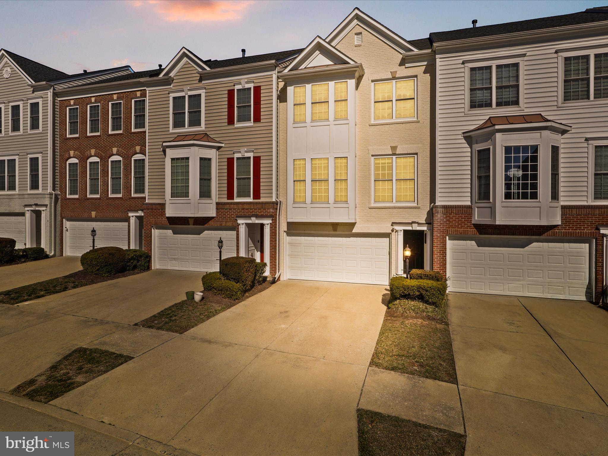 Welcome to the beautiful Fairlington model in desirable gated community of Potomac Club! This gorgeous three-level townhome with a two-car garage has it all! On the main level, you’ll discover an expansive, open floor plan with multiple bump outs, gleaming hardwood floors seamlessly flowing from the living room into the formal dining area. Custom built-in shelves sand trim surrounds the gas fireplace and large windows flood the rooms with natural light, making this space perfect for entertaining. Down a few steps, the stylish gourmet kitchen boasts high ceilings, rich cherry cabinets, sleek granite countertops, top of the line stainless steel appliances, and classic under cabinet lighting. With a stunning wall of windows, the morning room offers a delightful light-filled spot to enjoy casual meals. Upstairs, the elegant primary bedroom suite features an exquisite tray ceiling and plush carpeted floors, plus a large walk-in closet. Inside the bright en suite bathroom, you’ll find a wide double sink vanity, step-in shower, and soothing soaking tub. The spacious secondary bedrooms include soft carpeting, and wide closets, with access to the second full bathroom in the hall. The laundry  area with full size washer and dryer is conveniently located at the bedroom level. Downstairs on the lower level, the recreation room is a comfortable space for hanging out, and includes an additional half bathroom. With an abundance of natural light and picturesque views, the gym space could also be used as a home office which can be the perfect space to take your conference calls in peace and quie. Walk outside from this level to enjoy your open backyard, surrounded by mature trees, or step out onto your private deck to enjoy your morning coffee or tea. On the front of the home you’ll have plenty of room for parking and storage, with a wide driveway and two-car garage, custom paint and organizational systems. The roof and hot water heater are brand new (2024), for greater peace of mind. Luxurious Potomac Club community offers exclusive access to indoor and outdoor pools, sauna, fitness center, multi purpose courts,  playgrounds, clubhouse, and business center. Just minutes to Wegmans, Stonebridge at Potomac Center, Potomac Mills, Alamo Drafthouse, Sentara Medical Center, and Neabsco Regional Park. Get around town and commute easily with quick access to I-95, VRE, Park and Ride garage, and many commuter routes. Schedule a private tour of this Gem today!