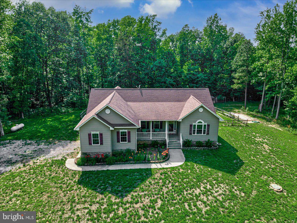 Peaceful country living on 10 private acres in King George County. This custom-built, one-level home offers space, privacy, and the kind of quiet setting that’s hard to find.  Outside, enjoy your own private trail system winding through the back of the property-ideal for exploring, hunting, recreational shooting or simply enjoying nature right in your backyard.
Inside, you’ll find vaulted ceilings that create an open, airy feel throughout the main living areas. The home features four bedrooms (the fourth bedroom, located downstairs, is not to code), providing flexibility for guests, an office, or hobby space. The primary suite offers comfort and function with double sinks, a large walk-in closet, and a spacious shower with two shower heads.  Downstairs, the unfinished walkout basement provides excellent storage and future potential. It is already plumbed for an additional bathroom and opens directly to the backyard, offering possibilities for expanded living space, recreation, or a workshop. If you’re looking for privacy, acreage, and one-level living in a peaceful setting, this property delivers the space to live, grow, and make your vision your own.