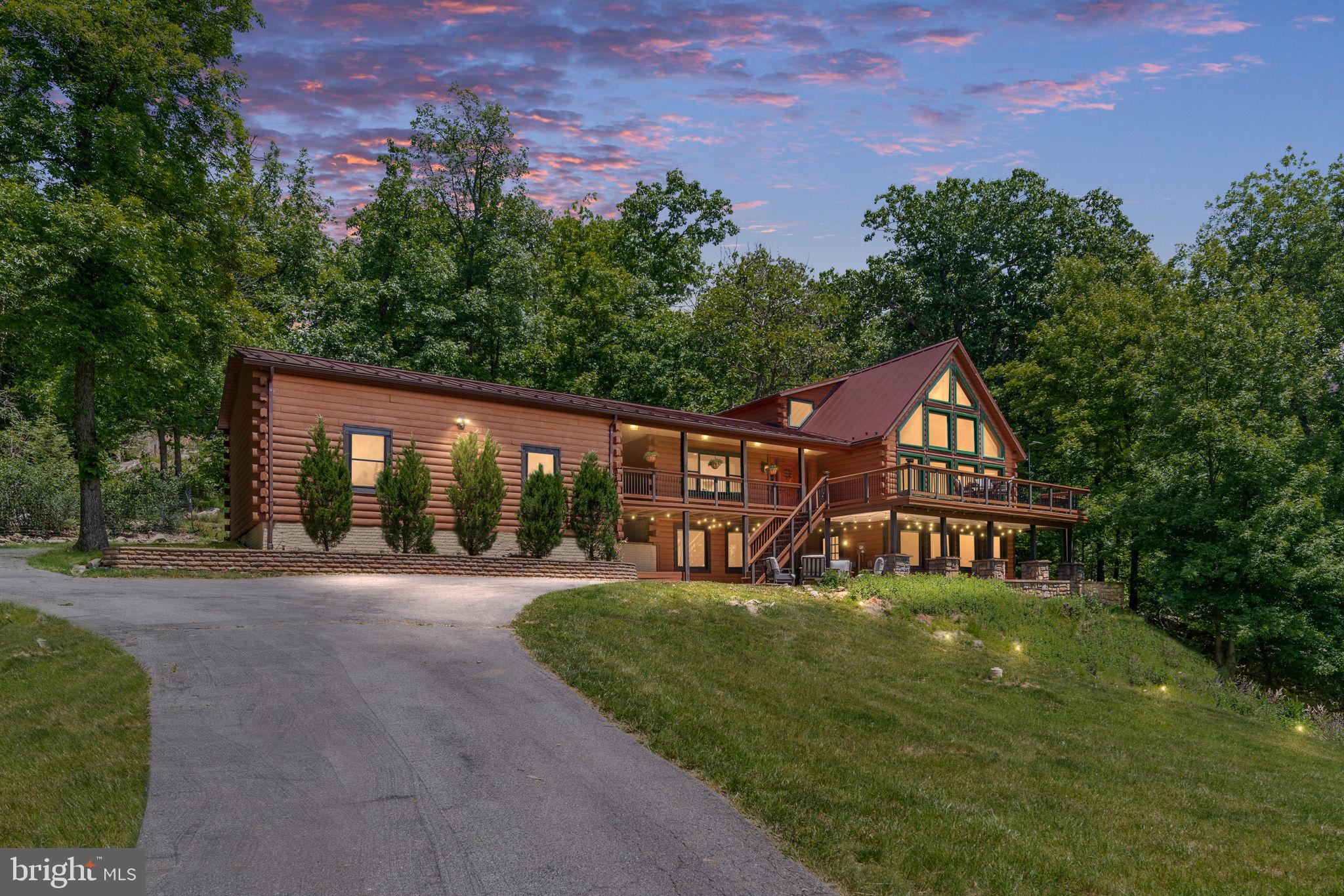 Welcome to the sought-after gated High Knob community, where mountain living meets modern comfort. From the moment you arrive, you'll understand this is not just a house, it's an entirely different way of living. Nestled on 2.22 private acres, this impressive 4-bedroom, 3.5-bath home offers breathtaking views of the Shenandoah Valley and Skyline Drive from its expansive deck.

The dramatic open-concept main level is anchored by soaring 19ft ceilings and floor to ceiling windows with custom shades that highlight the mountains, flooding every room with natural light and spectacular treetop views. The main level features a beautifully renovated (2021) eat-in kitchen complete with quartz countertops, oversized island, a ZLINE range, an abundance of upgraded cabinets and space for gathering. Hickory hardwood flooring flows throughout the main level, leading into the dramatic family room with a cozy pellet stove. The spacious main-level primary suite offers convenience and privacy, along with a renovated primary bath (2026) and direct access to a peaceful side porch—perfect for enjoying your morning coffee while taking in the mountain air.

Upstairs, a loft-style overlook provides views of the bright and inviting family room below and leads to an additional bedroom with its own full bath.

The finished lower level offers exceptional flexibility with a large recreation room, two additional bedrooms, a full bath, and a bonus room that could serve as a non-conforming fifth bedroom, home office, gym, or hobby space.

Additional highlights include a 3-car garage and the privacy and tranquility that make High Knob one of the area’s most desirable mountain communities. Residents enjoy an impressive array of amenities, including a clubhouse, swimming pool, tennis and basketball courts, playground, and community events throughout the year. Pool access, road maintenance, and the public water system are included in the sanitary district fee, making it easy to enjoy all that High Knob has to offer
