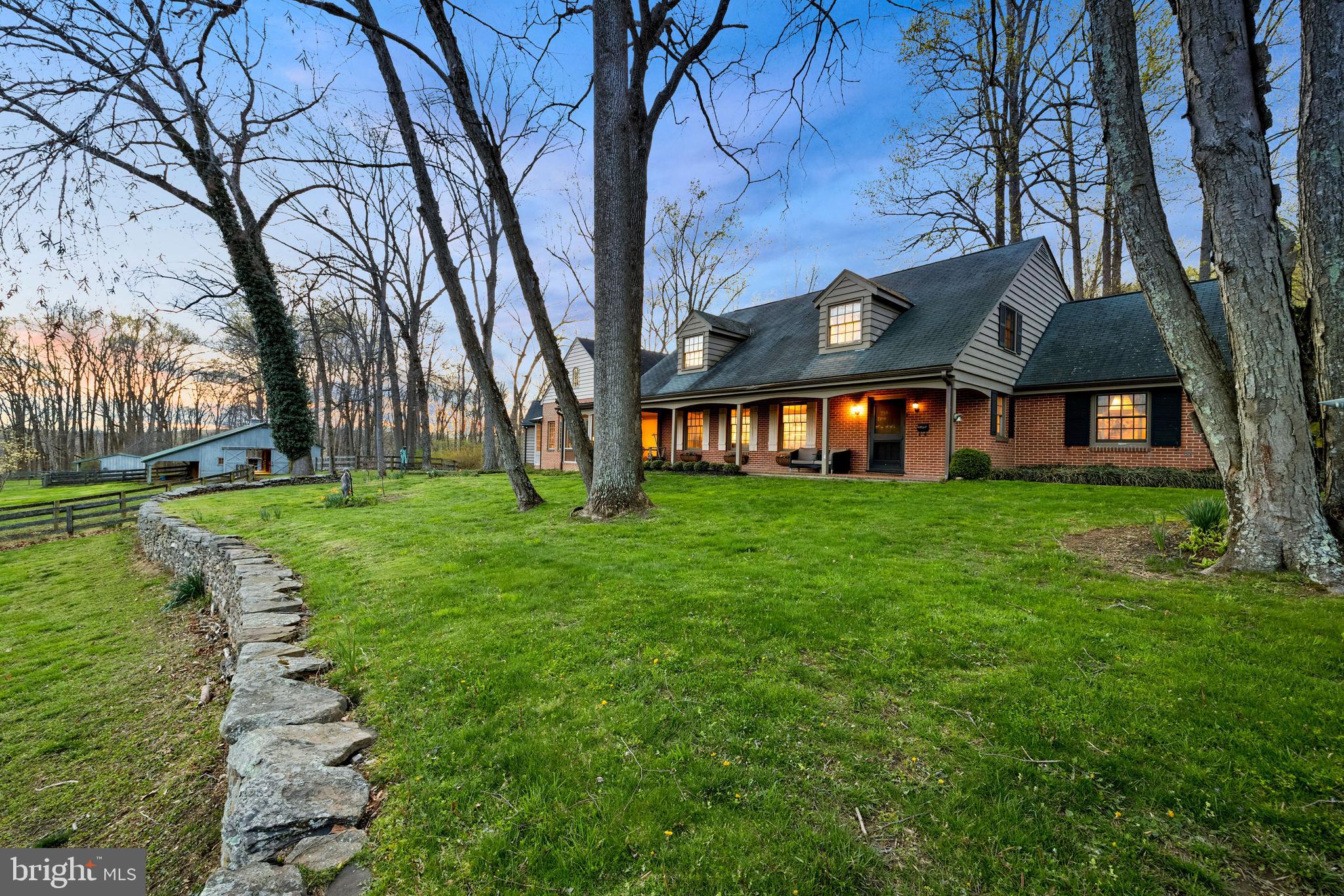 Find all the space and conveniences you need-with an exceptionally warm and cozy feel-in this one of a kind 5-bedroom, 3.5-bath Monkton farmette, set on more than 15 acres with a barn and pond. The heart of the home is a spectacular great room featuring soaring, locally-sourced wide plank ceilings and exposed wood beams; a working stone fireplace; custom wet bar with hammered copper sink, ice maker, and wine cabinet; and breathtaking views of rolling hills, stone walls, and grazing alpacas out front. 

The kitchen (with two dishwashers, wine fridge, freezer drawers, storage galore), huge primary suite (with private balcony, his and hers closets, 12+ ft. ceilings, separate laundry room), and home office overlook acres of protected land in the Maryland Environmental Trust out back. Tucked away amongst the backyard trees is a tranquil custom pool complete with waterfall, splash pad, in-pool seating, and diving rocks, while an expansive Trex deck provides plenty of room to entertain...plus, a five-minute walk out your back door takes you to the NCR trail. 

Lovingly maintained, the main home boasts a wide entryway, hardwood floors, lofted ceilings, custom built-ins, a first-floor Sonos stereo system, two additional laundry rooms, and tons of closets. One of the five bedrooms features its own bathroom and private entry, perfect for an in-law or au pair suite. The "round house"' a 2-bed, 1 full bath guest home or caretaker cottage, with 360-degree views, has an open layout and its own laundry. The property is three parcels conveyed as one. 

The barn comes equipped with a hot and cold wash stall, tack room, matted center isle, huge hay loft, and 3 stalls with the possibility of expanding to 6. There are 4 fully fenced paddocks, each with large run-in sheds, and Nelson waterers in the barn and fields. An equestrian's dream, with plenty of room to ride out, miles of trails, and access to the NCR. 

High-speed Internet, copper gutters, and a whole-house generator round out this special property, with easy access to rt. 83, Hereford Zone schools, and surrounded by beautiful Baltimore County horse country.