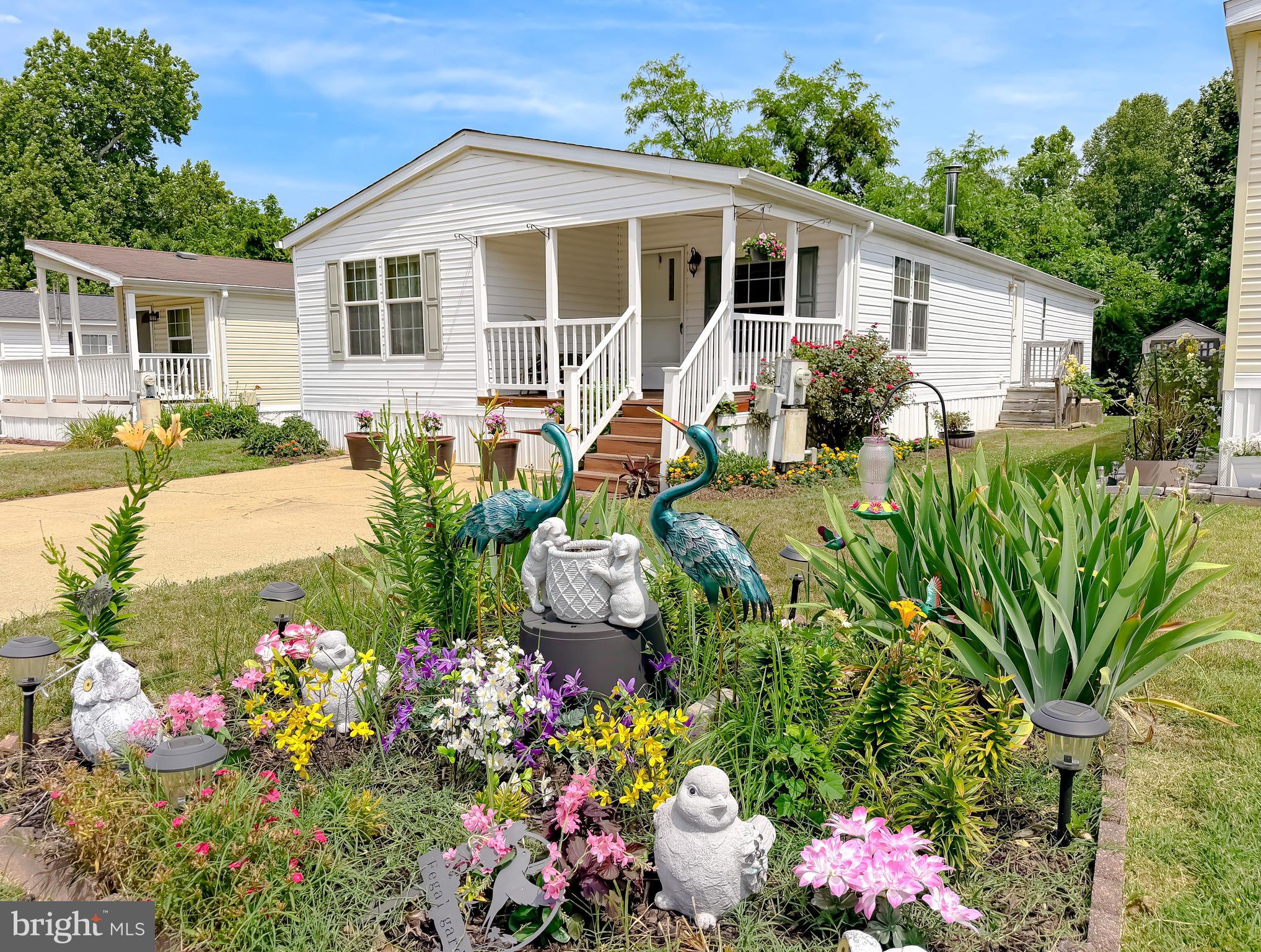 Buyer must be approved for Community Land Lease.-  2007 Double-Wide mobile home with 3 bedrooms and 2 baths in sought after Boones Estates.  Built in 2007 with new roof and gutter (4 yrs old), wood burning stove, ceiling fan, carpet, window treatments, double pane windows, entrance foyer, country style kitchen with breakfast nook, new dishwasher (2026), separate dining room with laminate flooring. Large primary bedroom with walk-in closet, large soaking tub, separate shower and granite vanity.  Two additional spacious bedrooms, full bath and laundry room with washer and dryer as well as outside access.  Bright bonus room on front for a sitting area, guest area or office.  Covered front porch to relax and enjoy beautiful flowers.  Extra large shed with built-in shelving for additional storage.  Seasoned hardwood for wood stove and all garden tools stored in shed to convey with your new home.
Discover the relaxed lifestyle of Boones estates in a serene environment well the surroundings are well-maintained.  Community amenities include Olympic-sized outdoor swimming pool, playgrounds, sidewalks, recreational facilities, basketball court, tennis court, freshwater pond, pet friendly and on-site staff.  Each home features off-street parking.
This is an ideal location close to Washington, D.C., Annapolis and the Chesapeake Bay.