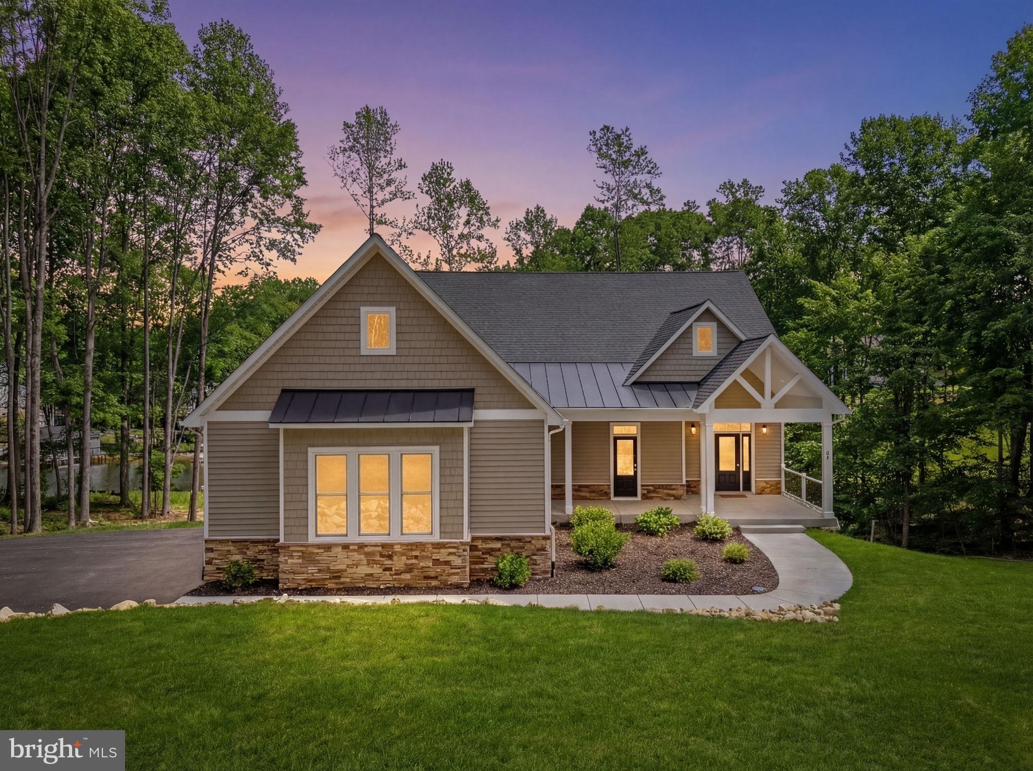 Recently constructed in the highly-coveted lakeside Mill Run community, this fully-furnished and thriving waterfront short-term rental sits on over 200 feet of shoreline within the exclusive private side of Lake Anna.  Here, you can start welcoming your guests (and depositing dollars)  the moment you close.  Generating strong rental income from day one with zero setup required, this stunning fully-equipped waterfront retreat is nestled in a peaceful cove offering exceptional water views and over 4,800 square feet of thoughtfully designed living space in a beautiful Craftsman-style home, featuring 5 large bedrooms, a loft, large finished basement and 4.5 baths.  Showcasing over 200 feet of shoreline, this exceptional property is designed to maximize lake views, luxurious comfort, and unforgettable gatherings. Enjoy outdoor living from an expansive lakeside deck, a double-decker boathouse, or a hot tub overlooking the water, creating the perfect setting for relaxing after a day on the lake.  Inside, the open and airy floor plan is thoughtfully designed for both everyday living and effortless entertaining. At the heart of the main level is a breathtaking great room with soaring high-vaulted ceilings and dramatic floor-to-ceiling glass that frames sweeping water views of Lake Anna — flooding the space with natural light and bringing the beauty of the water indoors at every turn. A stunning stone fireplace anchors the room, adding warmth and elegance whether you’re hosting a crowd or enjoying a quiet evening alone.  Flowing seamlessly from the great room, the enormous chef’s kitchen is a showstopper in its own right, featuring quartz countertops and high-end upgrades throughout, and an open layout that connects effortlessly to the living area — making it the perfect hub for entertaining, family gatherings, and everything in between. The main floor is further complemented by a luxurious primary bedroom suite — a true retreat unto itself — featuring direct deck access, a generous walk-in closet and a spa-inspired en suite bathroom complete with a freestanding soaking tub, double vanities, quartz countertops, and an elegant tile walk-in shower. A guest bedroom is also available on the main level.   Upstairs, a versatile loft area provides the perfect flex space for a lounge, home office, or reading nook, accompanied by two additional well-appointed guest bedrooms ideal for family and visitors. Downstairs, the expansive finished basement takes entertaining to the next level, offering a full-sized  wet bar, large recreation area, games, full-blown movie theater, and an additional oversized bedroom with bunks — giving everyone in the group their own comfortable space to unwind.  Modern conveniences include a Tesla Universal EV charger in the oversized two-car attached garage, high-speed fiber internet access, a full-size washer and dryer and mudroom.  Every detail — right down to the furnishings and décor — has been curated to create a welcoming and luxurious waterfront experience that guests return to again and again.  Whether you’re looking to expand your investment portfolio, secure a luxury vacation home that pays for itself, or settle into a full-time waterfront residence, this property checks every box.  Short-term rentals are not only permitted but already proven here, offering outstanding income potential in one of Lake Anna’s most desirable waterfront locations. Enjoy the tranquility of private-side lake living, breathtaking water views, and direct lake access from your own backyard — and step into a fully furnished, established rental business while creating memories that will last for generations.