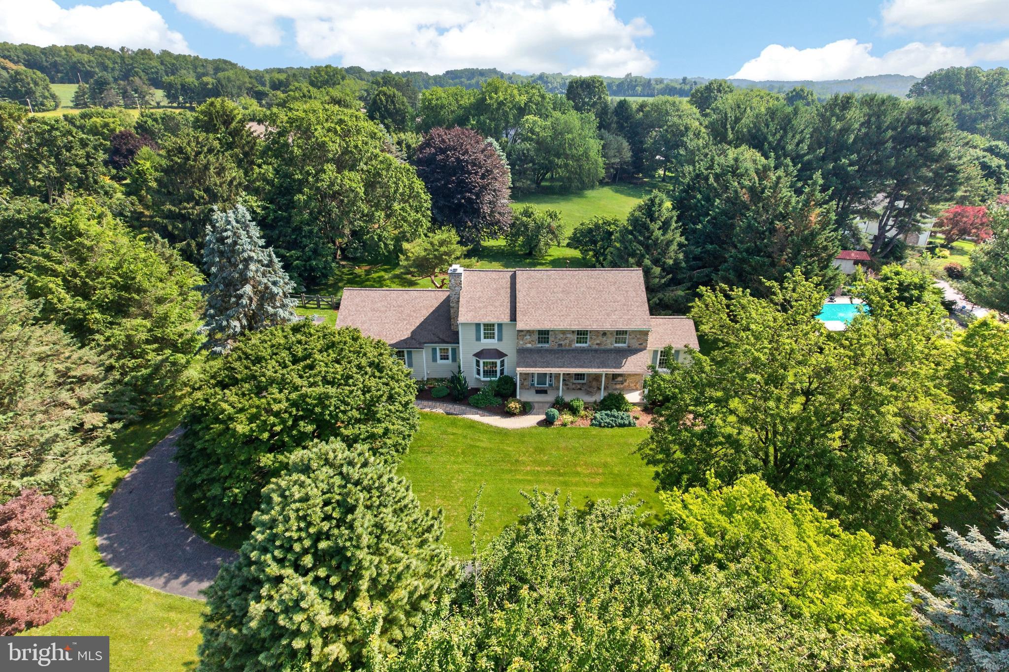 Welcome to 153 E Doe Run Road, an impeccably updated, light-filled spacious 4-bedroom, 2 1/2-bath home offering approximately 3,464 square feet of finished living space in sought-after East Marlborough Township and the award-winning Unionville-Chadds Ford School District. Set on a gorgeous property with mature landscaping and beautiful gardens, this pristine home features a renovated kitchen with breakfast dining bump-out, first-floor sunroom/office, hardwood flooring throughout much of the main level, first-floor laundry/mudroom, a finished walk-out lower level, and extensive improvements throughout.

Thoughtfully and significantly renovated, this home offers tremendous value, comfort, and peace of mind. Major improvements include newer HardiePlank siding, newer windows, newer roof, Velux center-pivot skylights, a stone chimney exterior, replaced copper roofing over the bay window, an Azek composite deck with Westbury VertiCable railing, a renovated front walkway, updated flooring in key living spaces, fresh interior painting throughout the main and upper levels between 2020 and 2023, new garage doors, replaced garage door opener, and a portable generator with manual disconnect setup for essential home circuits.

The renovated kitchen is a true centerpiece, designed for both everyday living and entertaining. Fully renovated in 2021, it features a bright breakfast dining bump-out, center island with electric cooktop and downdraft vent system, Bosch appliances, quartz countertops, custom cabinetry by Kahle’s Cabinets, custom tile backsplash, under-cabinet lighting, recessed lighting, new engineered hardwood flooring, and an easy connection to the main living spaces.

Just off the kitchen, the spacious step-down family room is filled with natural light and features 9-foot ceilings, updated engineered hardwood flooring, a stone fireplace, deck access, and a beautiful bay window that makes the room feel especially bright and inviting. Natural light is truly one of the defining features of this home, from the sunny kitchen bump-out to the family room bay window to the skylights upstairs.

The main level also includes a formal living room and dining room with updated solid hardwood flooring, along with a light-filled sunroom/office featuring vaulted ceilings and a ceiling fan. The renovated laundry/mudroom and powder room add everyday function and polish, with tile flooring, a new laundry tub, replaced closet doors, and refreshed powder room finishes including a new vanity, mirror, and light fixture.

Upstairs, the spacious primary suite offers a walk-in closet and a beautifully renovated primary bathroom completed in 2023. The bath was fully renovated down to the subfloor and includes new tile flooring, custom vanity, updated shower and shower enclosure, updated plumbing fixtures, a pocket door, and Velux skylights. Three additional roomy bedrooms, a hall bathroom, hallway linen closet, and pull-down attic stairs complete the upper level.

The finished walk-out lower level expands the home’s living space in a meaningful way, anchored by a generous main recreation room measuring approximately 23 by 25 feet. With a ventless gas fireplace, basement pantry shelving, an overflow refrigerator, and flexible space for media, fitness, play, hobbies, or guest overflow, this level adds impressive versatility.

Important system updates have also been completed, including central air conditioning replaced in April 2026 and furnace heat exchanger replacement completed in March 2024. Pre-listing inspections have already been completed, including home, septic, water, and structural inspections, giving buyers added confidence.

Outside, the property feels peaceful, established, and impeccably maintained, with spacious front and back yards, mature landscaping, beautiful gardens, a renovated front walkway, and inviting outdoor living on the Azek deck.

Located in the prestigious Unionville-Chadds Ford School District, ranked among the top distric