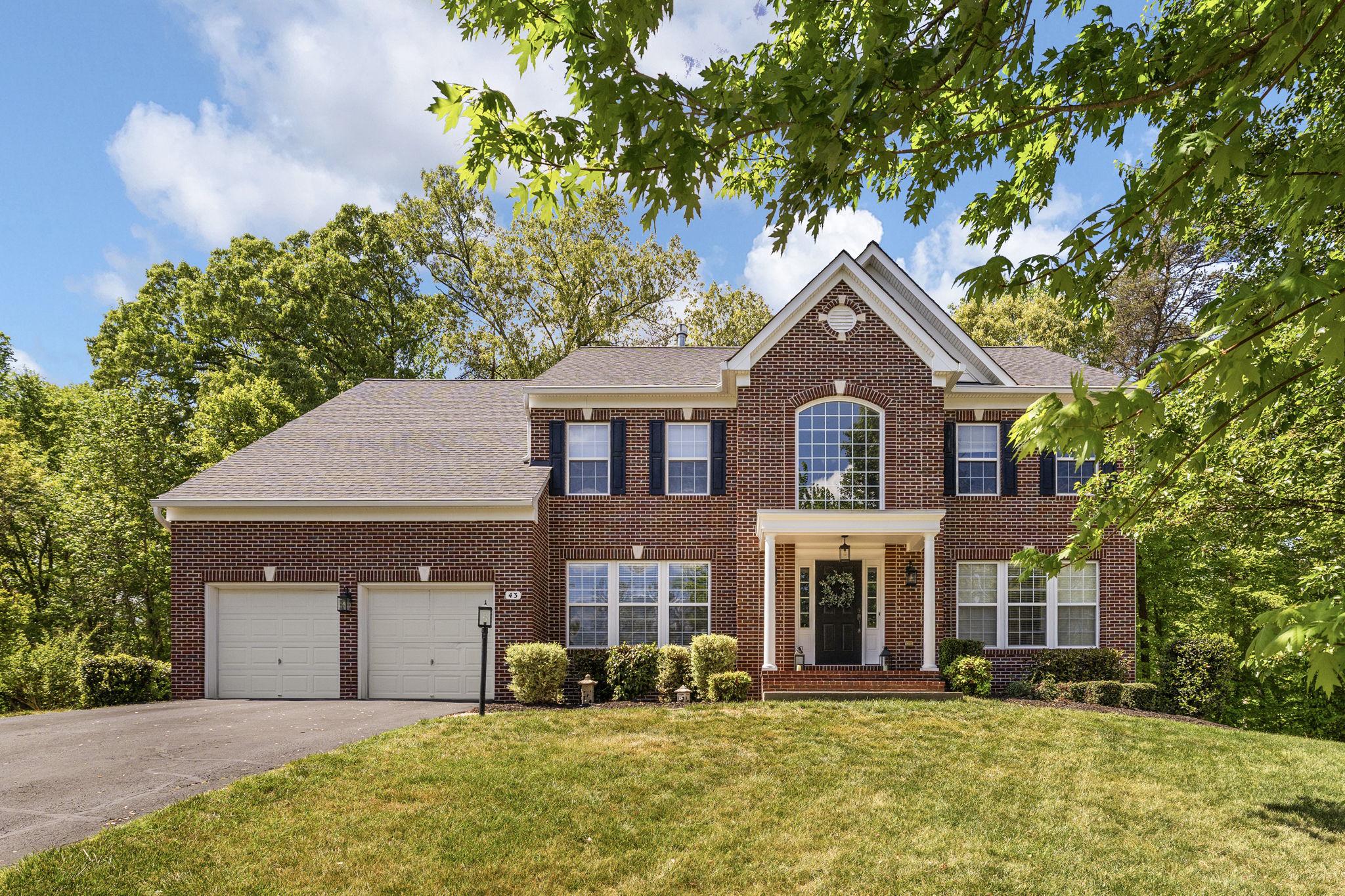 Welcome to 43 Adrian Way, an exceptional home where timeless elegance, generous space, and a serene natural setting come together on a private 1.19-acre cul-de-sac lot in the sought-after Deacon Road Estates community—just minutes from the VRE commuter lot for effortless commuting and convenient access to major routes, shopping, dining, and everyday amenities throughout Stafford. A charming front portico creates a warm and welcoming first impression, leading into a two-story foyer filled with abundant natural light. Rich hardwood floors extend throughout the foyer and into the inviting living room and elegant formal dining room, creating the perfect setting for memorable gatherings and everyday comfort. At the heart of the home, the beautifully updated kitchen is both stylish and functional, featuring refinished cabinetry, stunning quartz countertops, ample prep space, and a bright breakfast area bathed in sunlight. The kitchen opens seamlessly to the spacious and inviting family room, where oversized windows frame peaceful outdoor views and a cozy gas fireplace creates the perfect atmosphere for relaxing evenings and entertaining alike. A private home office on the main level offers the ideal blend of flexibility and convenience for remote work, study, or a quiet reading retreat. Upstairs, the luxurious primary suite is a true sanctuary. Unwind beside the striking double-sided fireplace, enjoy the private sitting area, and appreciate the expansive walk-in closets designed for both comfort and organization. Three additional generously sized bedrooms provide exceptional accommodations, including one with a private en suite bath and two connected by a convenient Jack-and-Jill layout. The mostly finished lower level offers incredible versatility with a spacious recreation area, full bath, and an enormous unfinished section ready to become a theater room, fitness studio, playroom, or additional living space tailored to your needs. Step outside to your own peaceful retreat—a stamped concrete patio overlooking a protected acre of mature woods and a tranquil stream. This rare and picturesque setting offers privacy, beauty, and endless opportunities to relax, entertain, and explore. With fresh paint, professional cleaning, and valuable recent updates including the roof (2021), HVAC systems (2022 & 2024), and water heater (2025), this meticulously maintained home is truly move-in ready. A seller-paid home warranty that will be transferred to a new owner adds even more confidence and peace of mind. Bright, refined, and beautifully updated with an unbeatable combination of comfort, charm, and natural beauty—43 Adrian Way is an extraordinary place to call home.