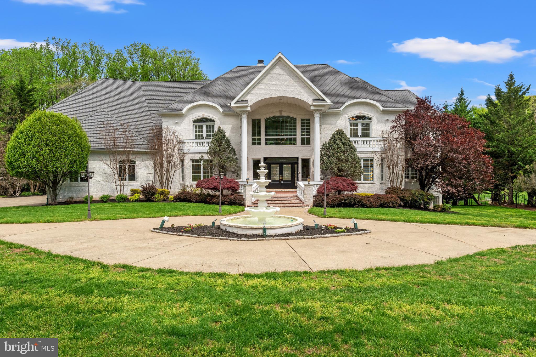 Extraordinary, luxury estate on two beautiful acres offering the best in Potomac lifestyle!  With a welcoming 4-tiered, front fountain, dramatic 2-story entry foyer with dual staircases, 6 bedrooms, 6 full bathrooms, 4 half bathrooms, a 4-car garage, elevator, gracious private and public spaces and an indoor pool, this fabulous property provides the best in family living and formal entertaining, all within two minutes of the shopping and restaurants of Potomac Village and Great Falls Park, with it's access to the C&O Canal, perfect for walking and biking adjacent to the magnificent Potomac River.  This home, built in 2002, has meticulous craftmanship and wonderful amenities throughout, from the gleaming wood floors, arched doorways, built-ins, custom moldings and walk-in cedar closet to its move-in condition and functional floor plan.  The main level includes formal living and dining rooms, a sunroom, library, 2-story family room with 2-sided, gas fireplace adjacent to the gourmet kitchen with granite island and breakfast room and level access to the spacious garage.  The upper level features the primary bedroom suite, complete with a balcony, sitting area, two walk-in closets, and a luxurious primary bathroom with Jacuzzi-style tub and shower stall. The upper level also includes a spacious upper level family room and three additional bedrooms, one with an en-suite bathroom and balcony and two with a connecting bath. The walkout lower level is an entertainer's dream, featuring a full kitchen/bar area, two guest or in-law suites, and an exercise room/dance studio.  The deck off of the main level with gazebo has amazing views of the expansive grounds backing to woods, and the indoor pool with automatic cover and balcony with entertaining space offers year-round swimming!  This house is ready to sell at this very attractive price!
