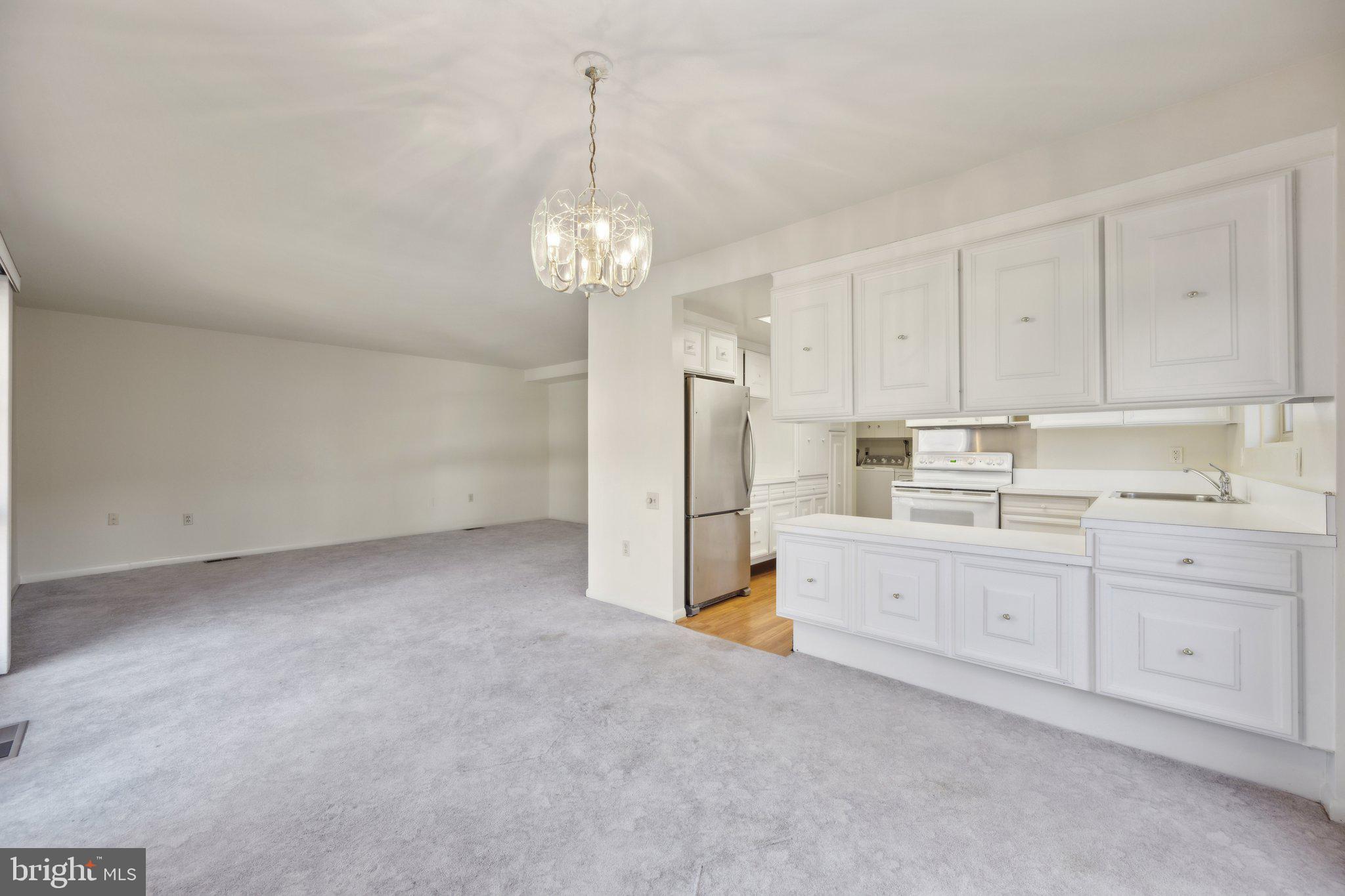 Discover comfort and convenience in this bright and open, 2-bedroom, 1.5-bath end-unit townhome with fresh paint, a bright and open layout giving you plenty of versatility for decorating. The main level features a spacious kitchen with an abundance of counter space and a stainless steel refrigerator. Enjoy the separate laundry closet, under stairs expansive storage and glass slider off the dining room.  Step out onto the fenced-in patio off the dining room that is great for entertaining and relaxing. Upstairs you’ll love the spacious bedrooms with hardwood floors and expansive closets and built in shelving.  
The 55+ gated community offers resort-style amenities, including 2 clubhouses, a fitness center, indoor and outdoor pools, walking trails, tennis courts, game rooms, and an 18-hole golf course. With a variety of clubs and activities, there’s always something to enjoy. Conveniently located near grocery stores, banks, restaurants, the ICC, and downtown Rockville. Don’t miss this opportunity for peaceful, low-maintenance living!