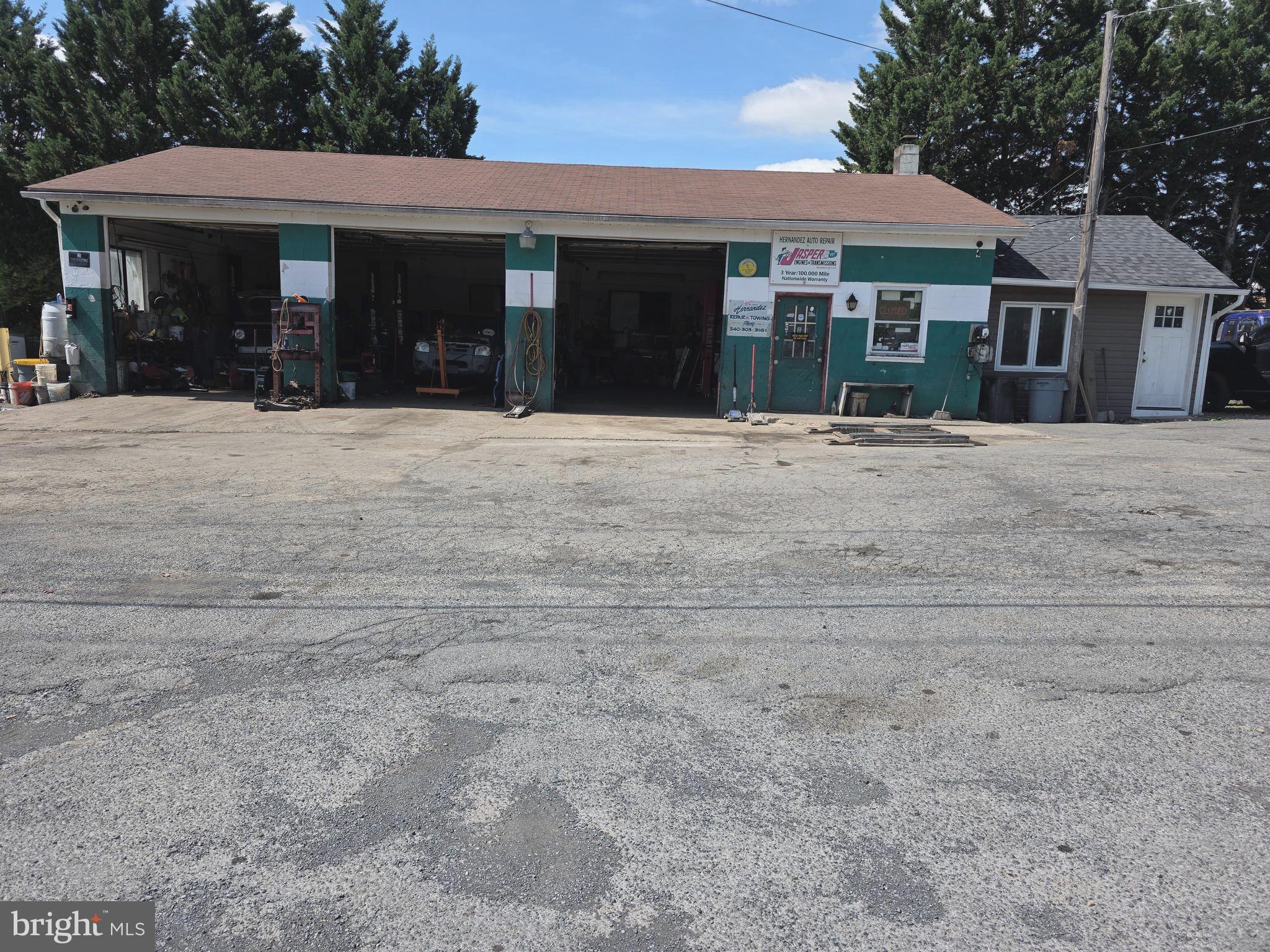 Repair shop with 3 bay garage.  3 car lifts.  Property has a small  3 bedroom home for extra income that can be rented out.   Fenced in lot with lots of parking spaces.  Located just off of 522 south close to town.