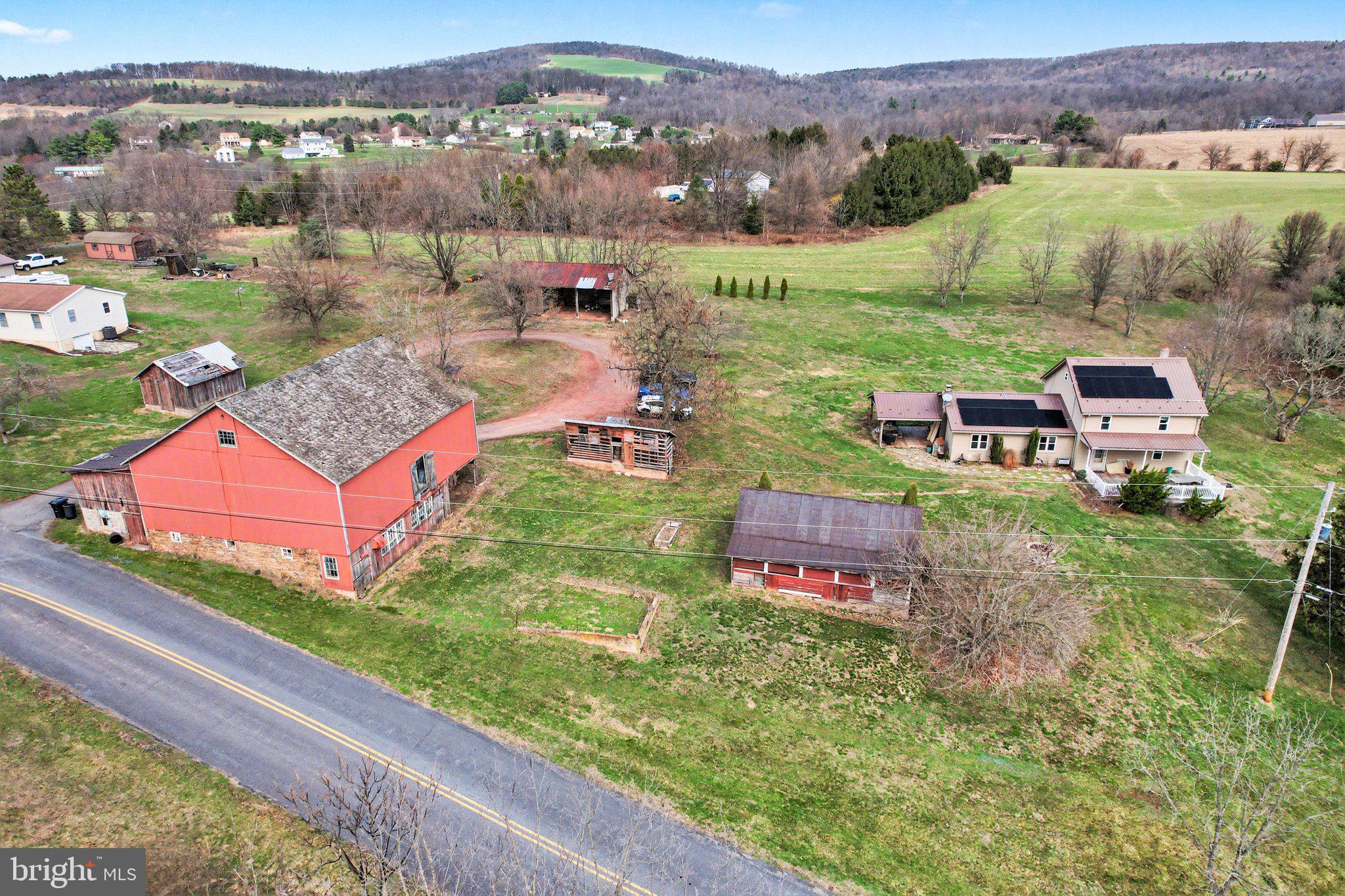 Welcome to this beautiful 4+ acre country property offering the perfect blend of comfort, functionality, and peaceful rural living. Featuring a pond, a spacious barn well-suited for housing animals, and multiple outbuildings, this property is ideal for those looking to start a homestead, create a farmette, or simply enjoy extra space and privacy.

Enjoy stunning country views in every direction and frequent wildlife sightings right from your own backyard—adding to the peaceful, nature-filled setting this property offers.

The pond provides a nice focal point and a relaxing outdoor spot to enjoy the scenery.

Relax and take in the scenic surroundings from the large covered front porch or entertain with ease on the spacious covered side deck—perfect for grilling and enjoying the quiet countryside.

Inside, you’ll find an open-concept layout connecting the kitchen, dining, and living areas, highlighted by a pellet stove that serves as an efficient primary heat source. The main level also offers convenient first-floor laundry and a spacious primary suite complete with a walk-in closet and full bath.

Upstairs, there are two additional bedrooms and a full bathroom, providing comfortable space for family or guests. The home is equipped with four mini-split systems (two on each level) for added comfort, along with solar panels to help offset energy costs.

Located in unzoned Wayne Township, this property offers flexibility for a variety of uses. Enjoy the best of both worlds with a private, country setting just minutes from the Halifax shopping plaza and an easy 30-minute drive to Harrisburg.

Don’t miss this opportunity to own a versatile property with endless potential!