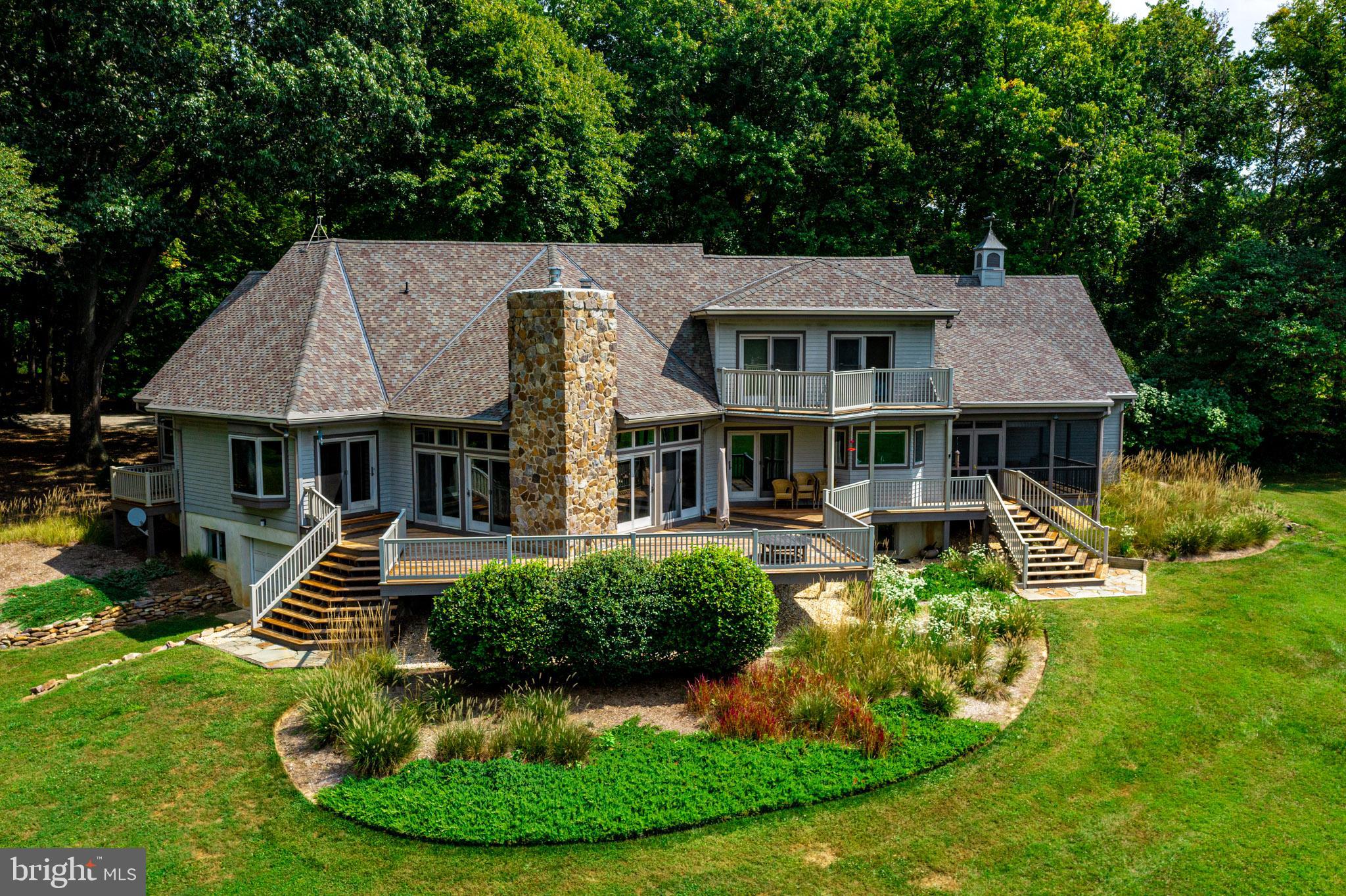 Custom  built house on the East Fork of Langford Creek set on 8+ acres with a private dock. This is the first time the house has been for sale; original owners. It was built by Patrick Jones and designed by architects Dunning & Dunning  from Swathmore, PA. Beautiful sunsets. & SW breezes.  It captures the lay out of the property and celebrates the water from every window. There is deep water (4.5 MLW, buyer to verify).  7-ton boat lift. Sunken living room with vaulted ceiling. White Oak floors through much of the house.  Designed for outdoor living. There is a deck, screened in porch, covered front porch. 2 car garage off  the kitchen. Storage area above the garage with separate outside access.  Huge basement, partially finished. Plenty of room for guests, a workshop, and a garage door for all the toys. Shown by appointment only. No drive by's please.   High speed internet.
