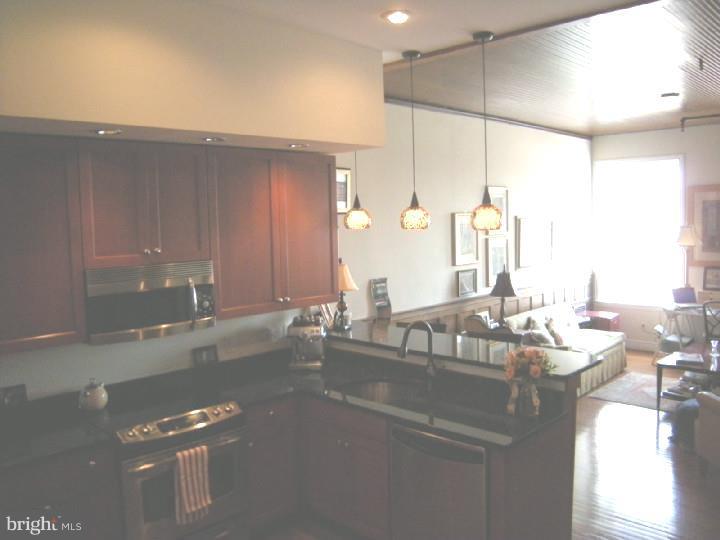 Spacious open living room and gourmet kitchen with stainless steel appliances and granite countertops. Large bedroom and tile bathroom. Washer & dryer. Good amount of closet space. Hardwood floors, huge windows. Apartment has been completely renovated and maintains a lot of the historic details of an old factory. Communal roof deck and bike storage in basement. Short walk to shops, restaurants and subway.