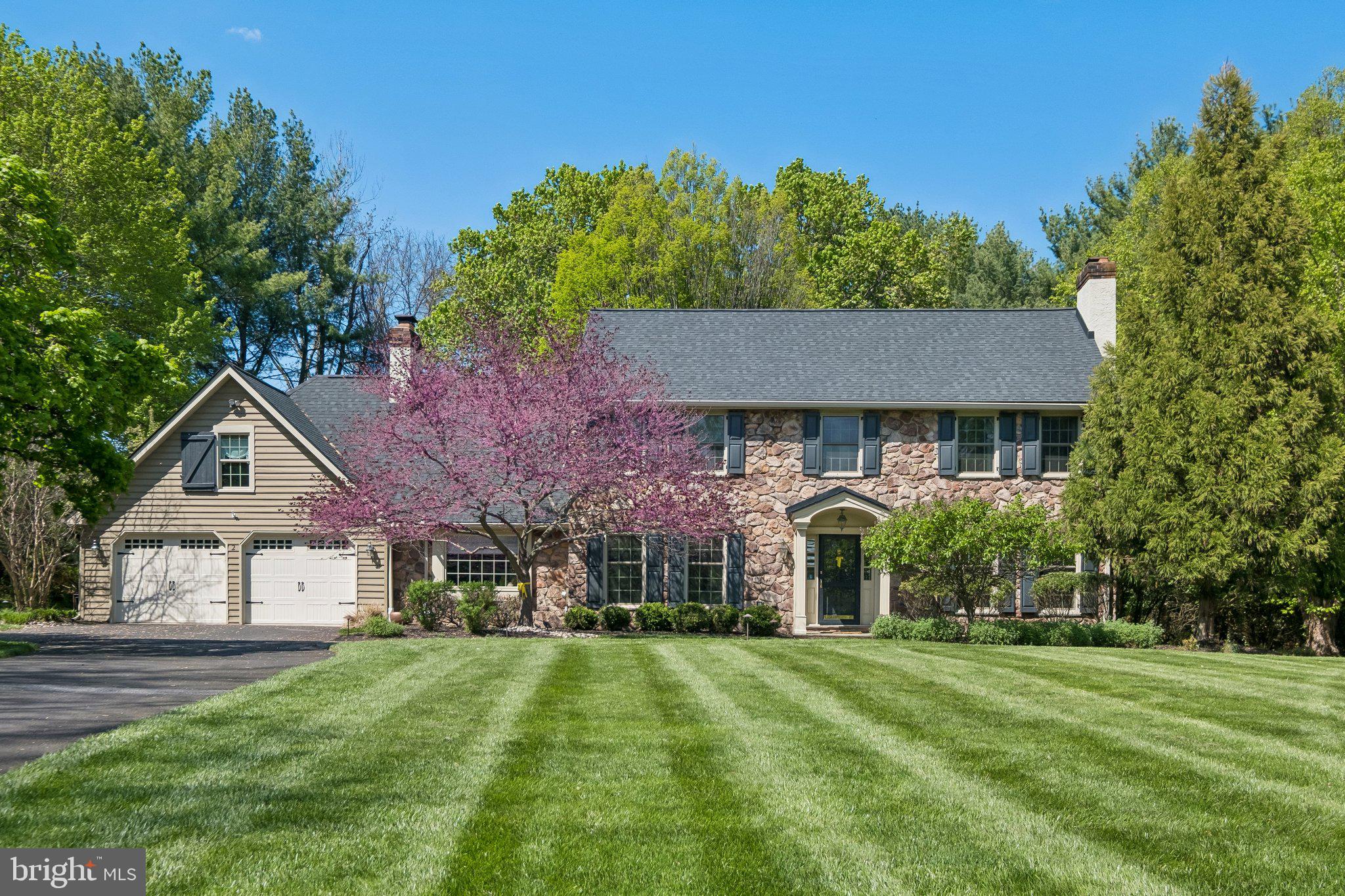 Welcome to this beautifully maintained 4-bedroom, 2.5-bath home located in the highly coveted Woodbridge Meadows community of Spring House, within Lower Gwynedd Township and the award-winning Wissahickon School District. Tucked away on a quiet cul-de-sac, this stately stone-front residence offers the perfect balance of neighborhood charm and private, peaceful living.

Step inside to a welcoming foyer highlighted by rich hardwood flooring, detailed millwork, and timeless finishes throughout. The main level features a formal dining room with a striking marble-accented wood-burning fireplace and direct access to the kitchen, along with a warm and inviting living room—perfect for hosting guests. The kitchen has been thoughtfully designed with a large custom island, 42-inch cabinetry, granite countertops, tile backsplash, premium stainless steel appliances, a pantry, and a warming drawer for added convenience. French doors lead to an expansive patio and a beautifully landscaped backyard, ideal for outdoor entertaining or quiet mornings.

Just off the kitchen, the family room offers a bright, open feel with a large picture window, exposed beams, custom built-ins, and a brick gas fireplace with glass doors. Sliders open to a spacious sunroom with a skylight, creating an additional light-filled retreat. A private study, bonus room, and powder room complete the first floor.

Upstairs, dual staircases provide access to the second level, where the primary suite serves as a true retreat with its own fireplace, a custom walk-in closet and dressing area, and an en-suite bath featuring a soaking tub and oversized tiled shower. Three additional generously sized bedrooms, a convenient second-floor laundry area, and a hall bath with double vanities complete this level. An additional 400-square-foot bonus space offers flexibility for a home office, playroom, or secondary living area.

The finished lower level adds approximately 800 square feet of versatile living space, perfect for a media room, gym, or recreation area, while still allowing for ample storage. The property is professionally landscaped front to back and is surrounded by scenic walking trails, ponds, and natural beauty within the community.

Recent major improvements include a new roof installed in 2023 and a brand-new HVAC system added in 2025, providing added peace of mind for years to come.

Conveniently located near Routes 73, 63, 309, and the Pennsylvania Turnpike, and just minutes from Spring House Village, Ambler, and Blue Bell, this home offers both accessibility and lifestyle. Thoughtfully updated and meticulously cared for, it’s ready for its next owner to move right in.