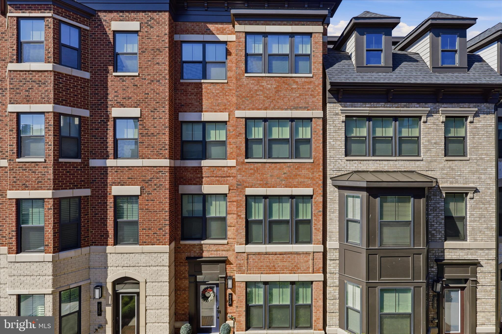 Welcome to 213 Market Sq NW, an exceptional residence in the heart of Vienna, VA, where sophisticated design meets an unbeatable location. Perfectly situated for a vibrant lifestyle, this home is just steps from the charming shops, restaurants, and local favorites of downtown Vienna, with immediate access to the beloved W&OD Trail. This home meticulously incorporates every premium upgrade offered by the developer and more, including a spacious 2-car garage equipped with a high speed EV charger. The main level is an entertainer's dream, featuring a living room with custom built-ins framing a cozy gas fireplace, and a dining room enhanced by a custom breakfast bar and integrated beverage fridge.The gourmet interior flows effortlessly to a covered outdoor balcony off the kitchen, which features a built-in gas fireplace and TV hookup for year round enjoyment. For the ultimate open air experience, the rooftop deck serves as the home’s crown jewel, complete with built in speakers and  with water and electrical hookups. Comfort is guaranteed with four spacious bedrooms, each boasting its own private ensuite bath and custom closets, offering unparalleled privacy for residents and guests alike.This residence is as smart as it is stylish, fully wired with Ethernet and dedicated access points on every floor for seamless, high speed connectivity. A multi zone Klipsch and Sonos speaker system flows throughout the home, allowing you to set the perfect ambiance in every room. Offering the rare combination of turn key luxury and technology forward living in a premier walkable community, 213 Market Sq NW is a truly unique opportunity to experience the very best of Town Center living.