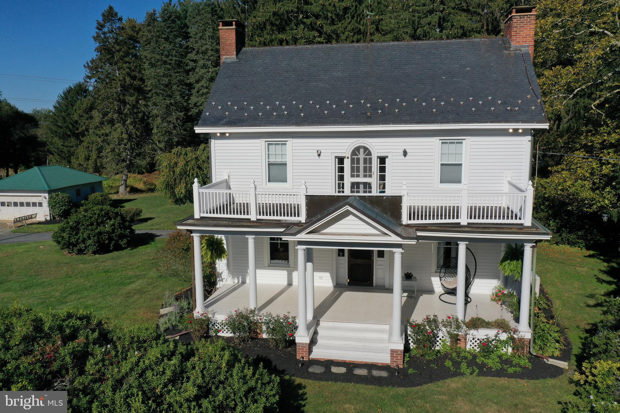 Homesteaders - make this splendid Country Estate your new home!  Early 20th Century charm with columned front porch and balcony overlooking a sweeping front yard and farmland. The home retains much of its original floor plan with center hall, 2 fireplaces, 2nd level library opening to the front balcony, stained glass windows and finished 3rd level with intriguing nooks and crannies. Updates (1995) include replacement, tilt-clean windows; expanded, updated kitchen and main level laundry. Summer fun beckons with the well-maintained in-ground saltwater pool with diving board and fully fenced enclosure. Pool Updates include the vacuum system (2024), pump system and cover.  Bring your farm animals to the spacious bank barn with vinyl fenced pasture and water to the barn.  The property is nestled among permanently conserved farm land and custom built homes.  Look for the detailed information, plat, maps in the MLS Documents and Brochure.  Video views available.